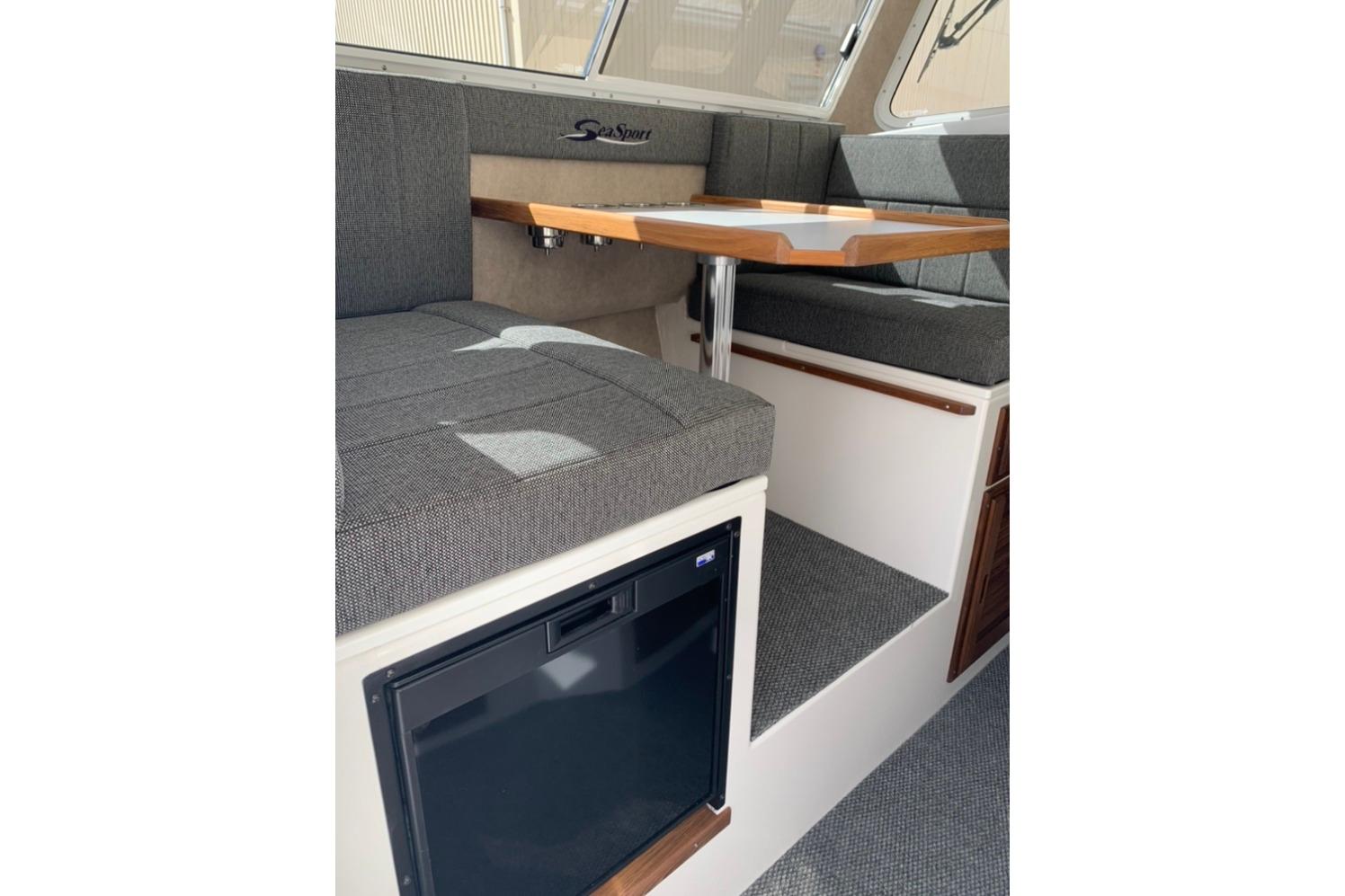 Interior of 2026 Sea Sport Kenai 2600 boat with seating and table.