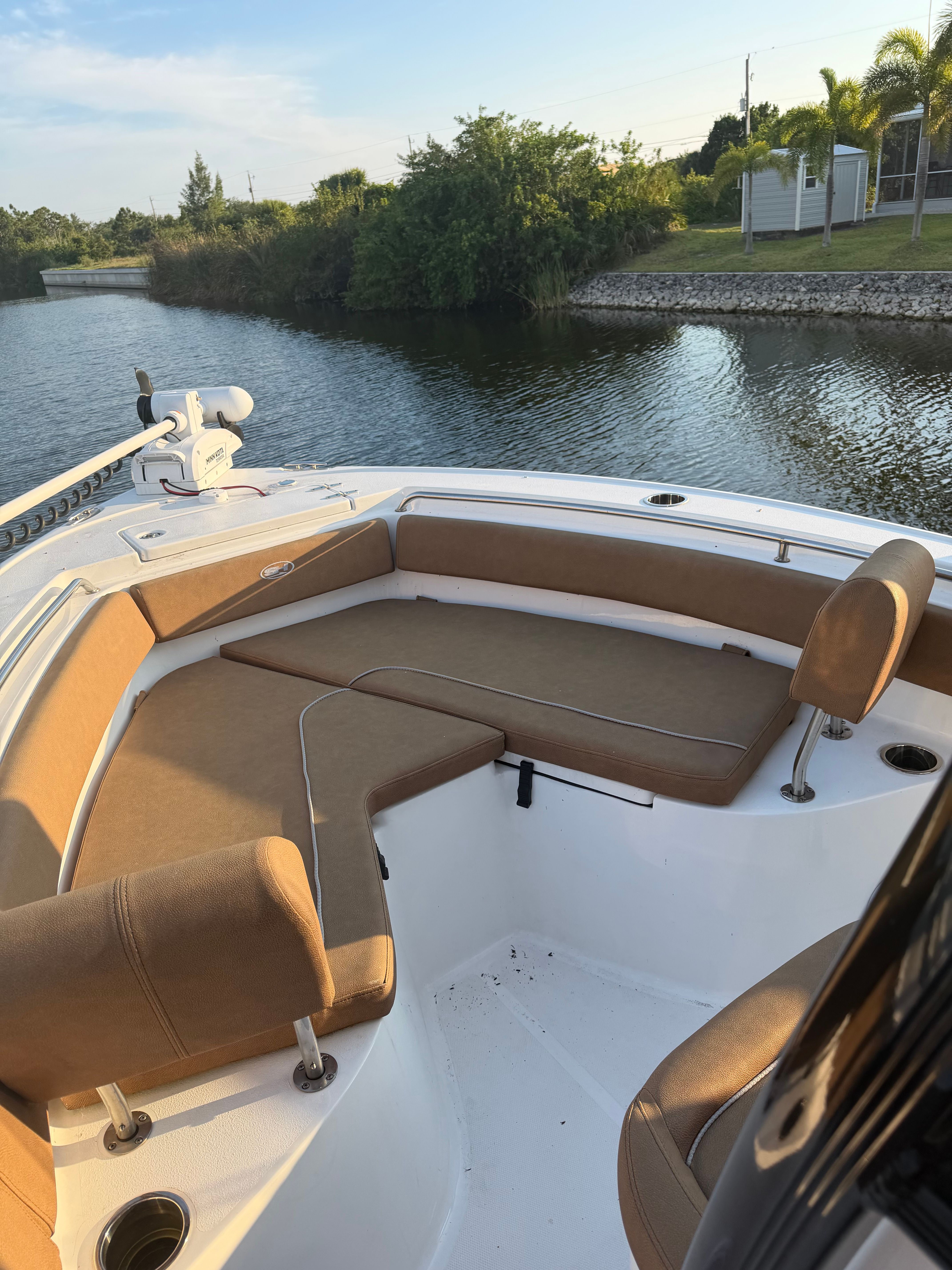 The image shows the bow of a 2024 Sea Hunt Ultra 219 boat with brown cushions.