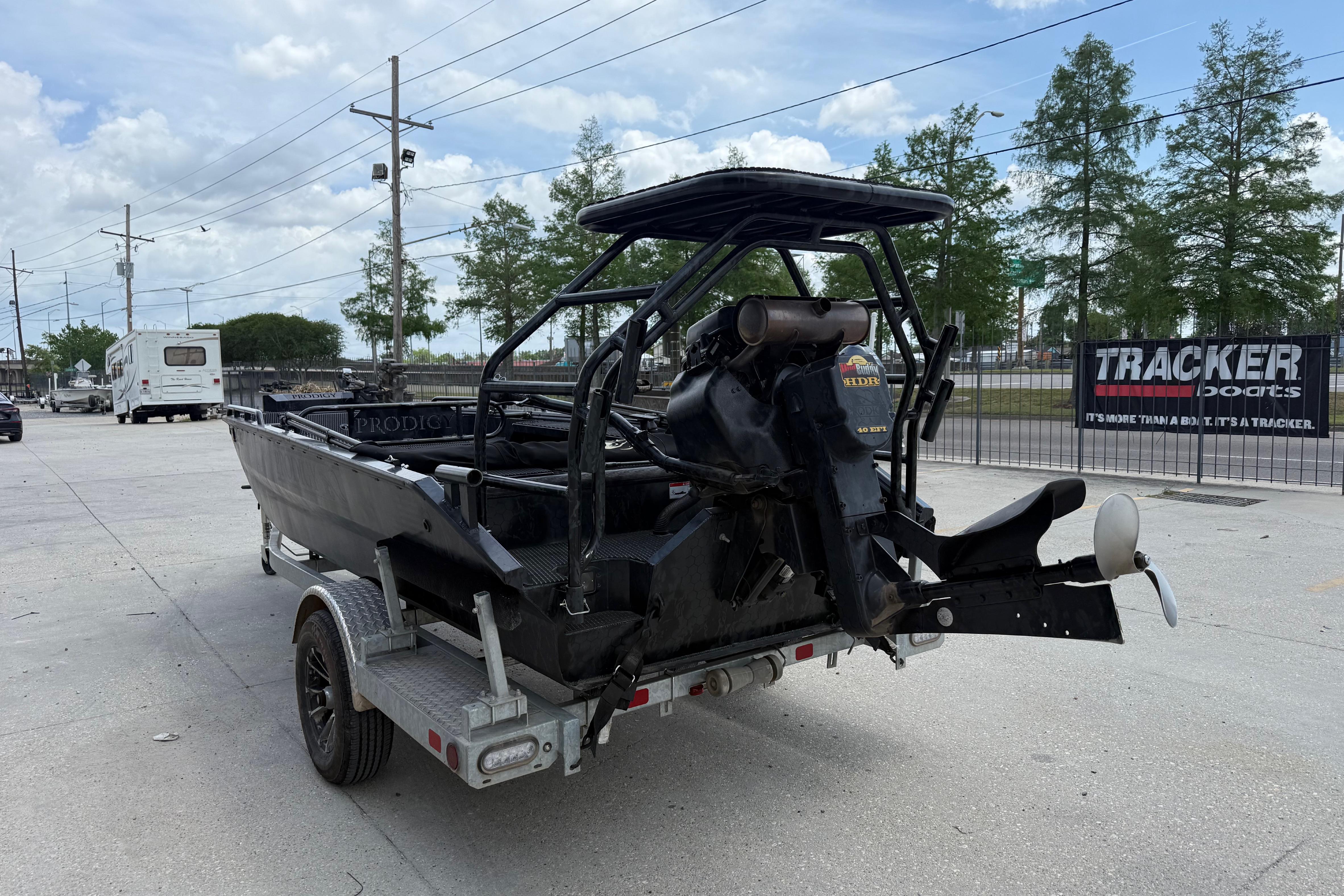 2024 Prodigy 17 boat on trailer, outdoor setting, overcast sky, Tracker Boats sign visible.