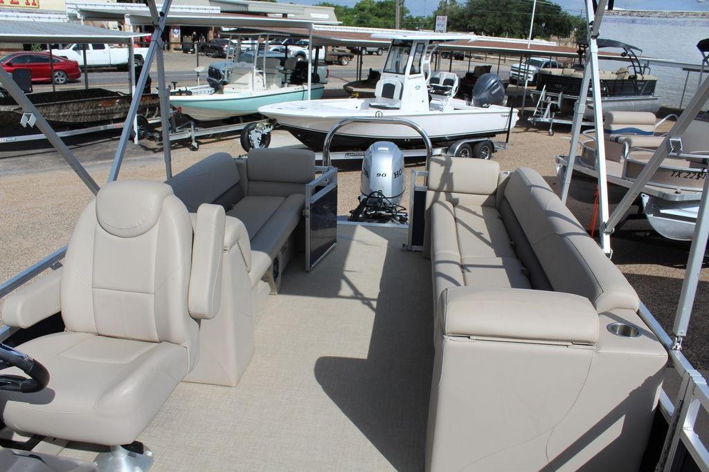 2021 Avalon VLS Quad Lounge 22 FT pontoon boat with beige seating and Honda motor.