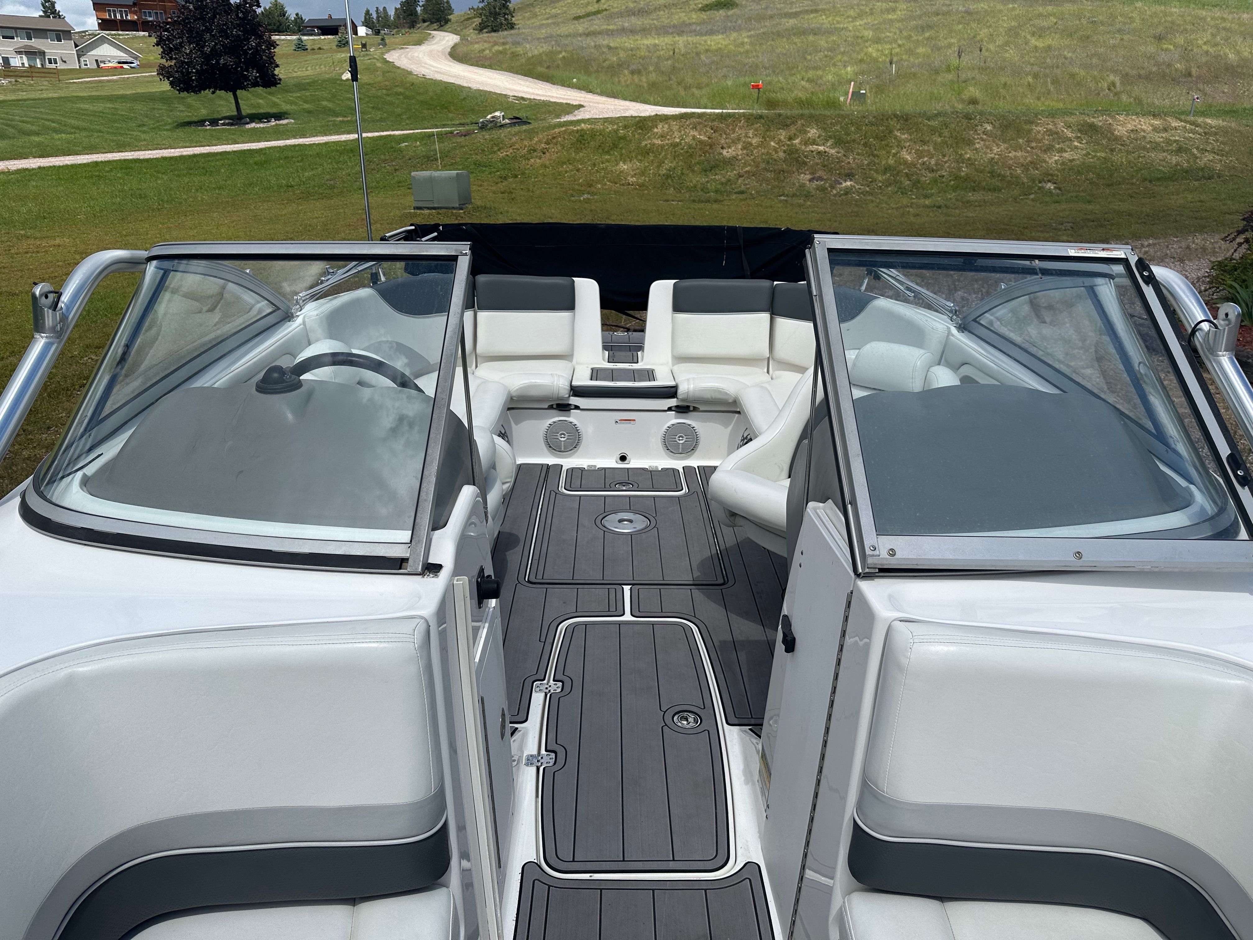 Interior view of a 2005 Yamaha AR230 HO boat on land.