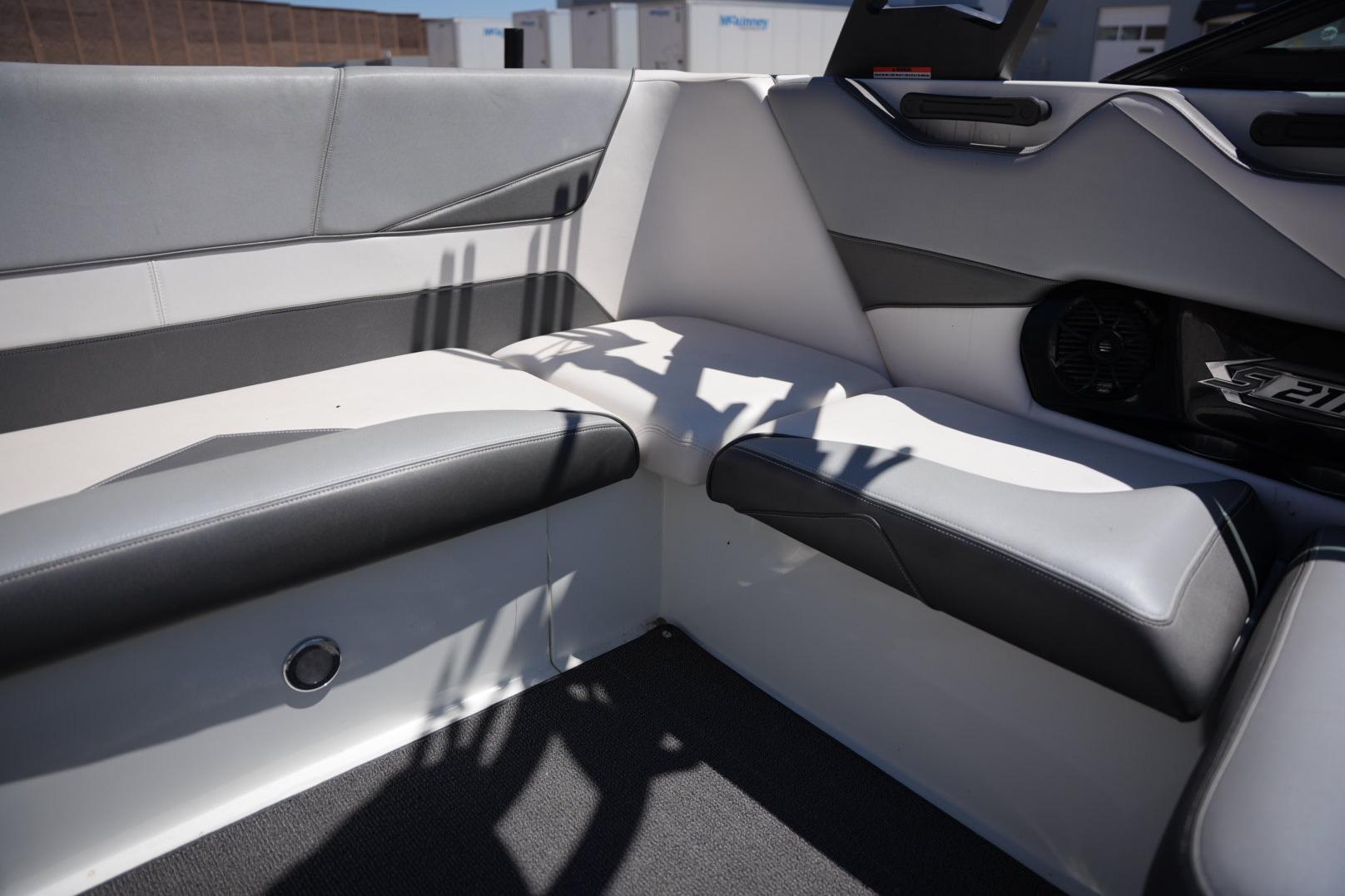 Interior seating of a 2016 Supreme S211 boat, featuring sleek gray and white upholstery.