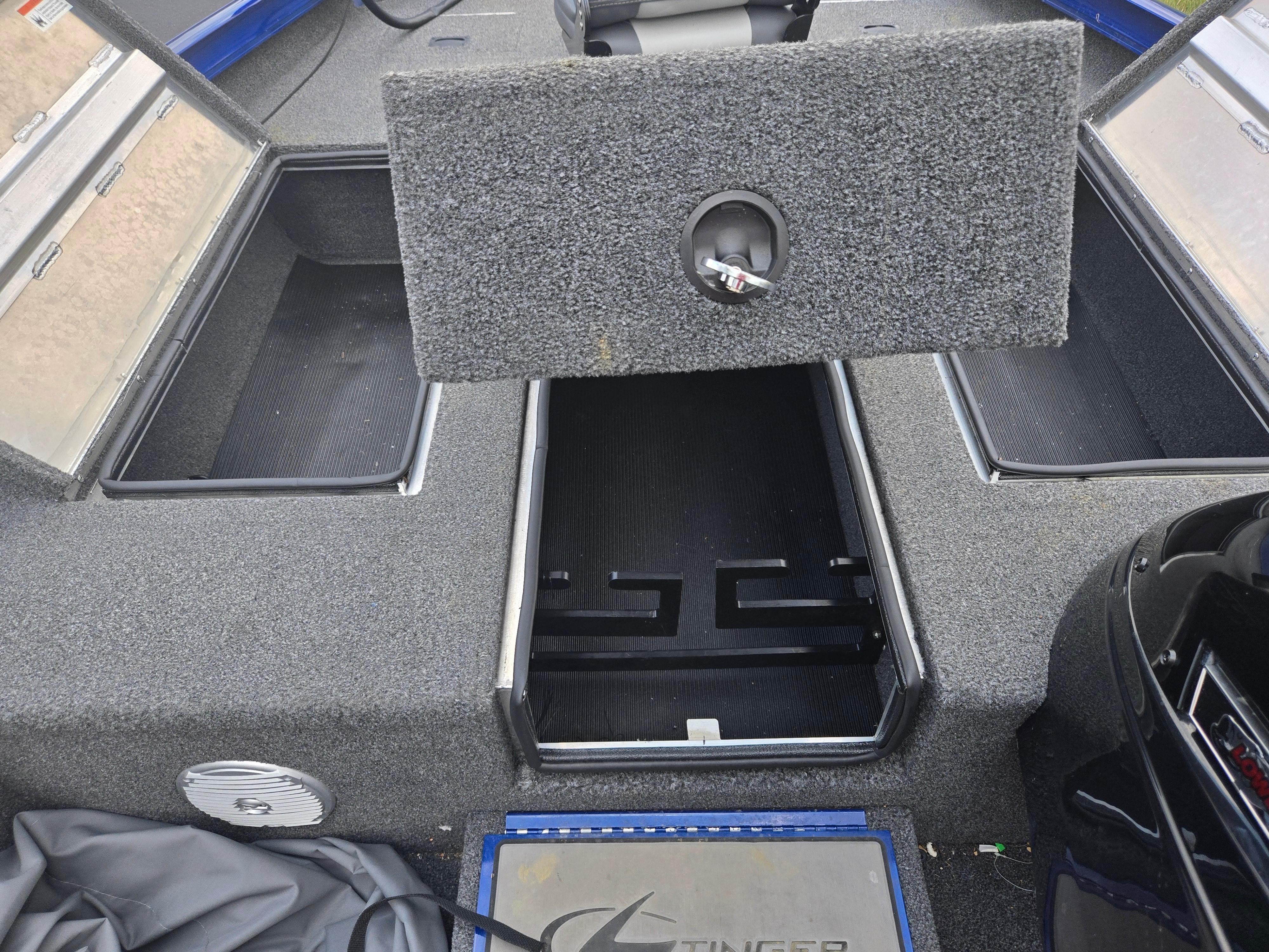 2021 Lowe Stinger 188 boat interior with open storage compartments and carpeted flooring.
