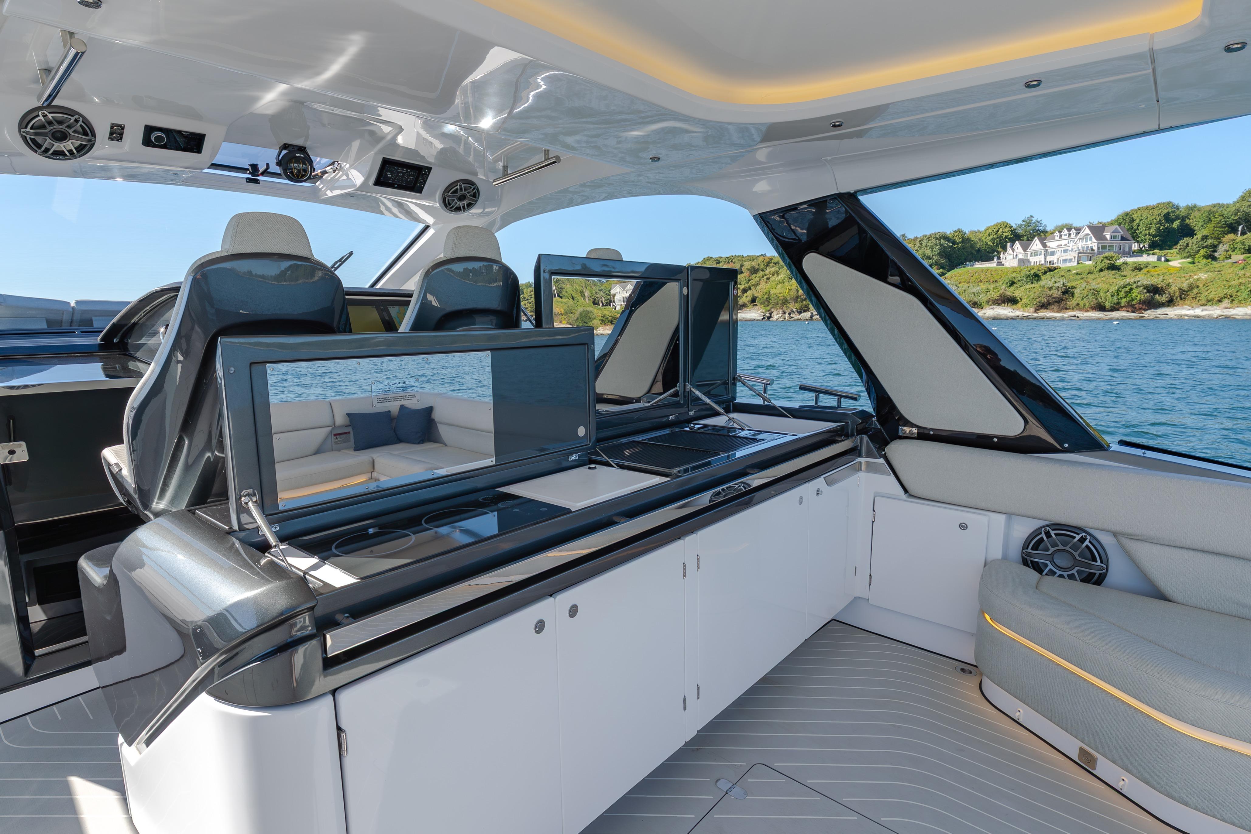 Luxurious interior of 2023 Azimut Verve 47 yacht with modern seating and scenic ocean view.