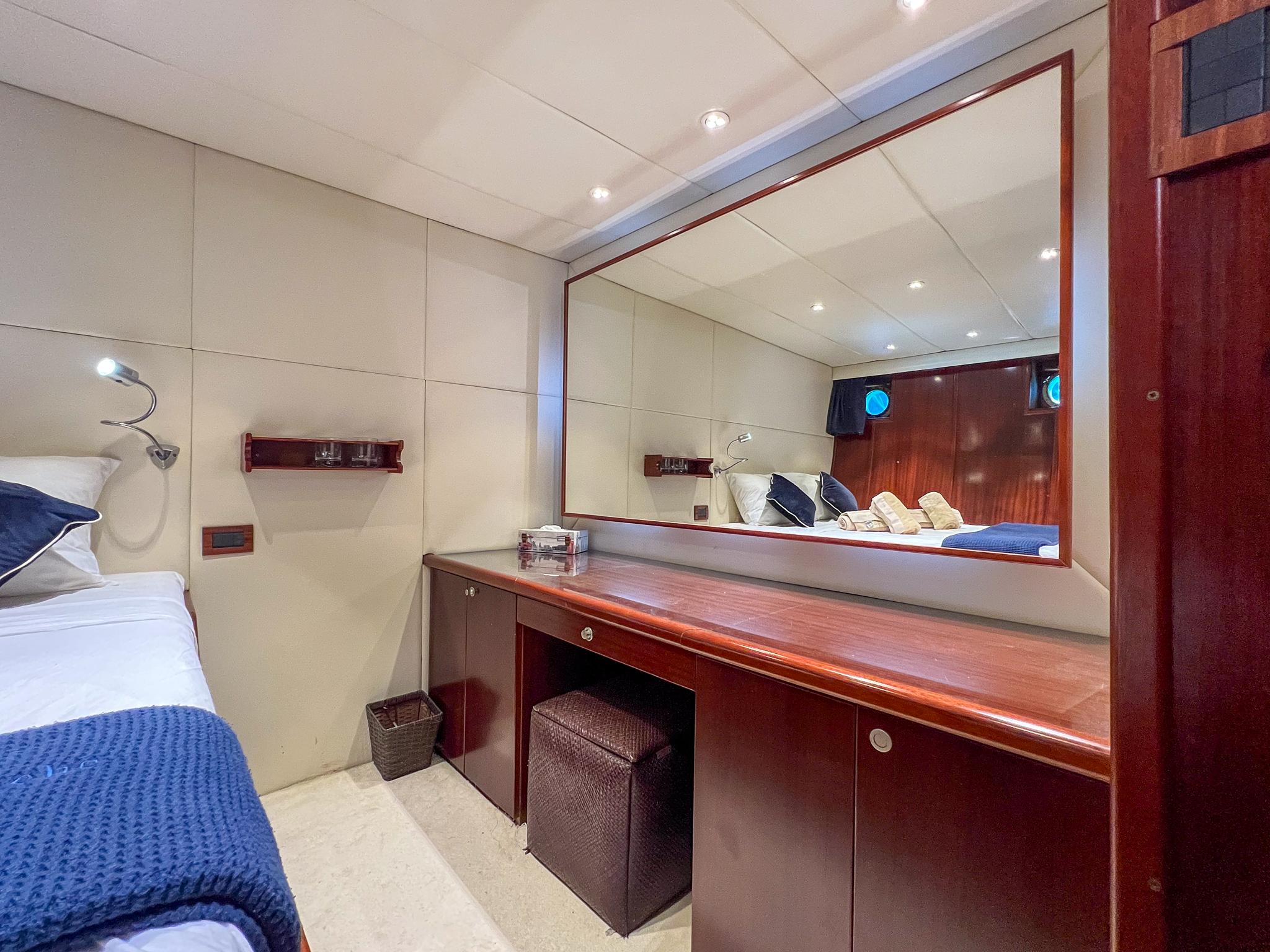 Luxurious cabin interior of 1969 Custom Psarros Shipyard yacht with elegant wood finishes.