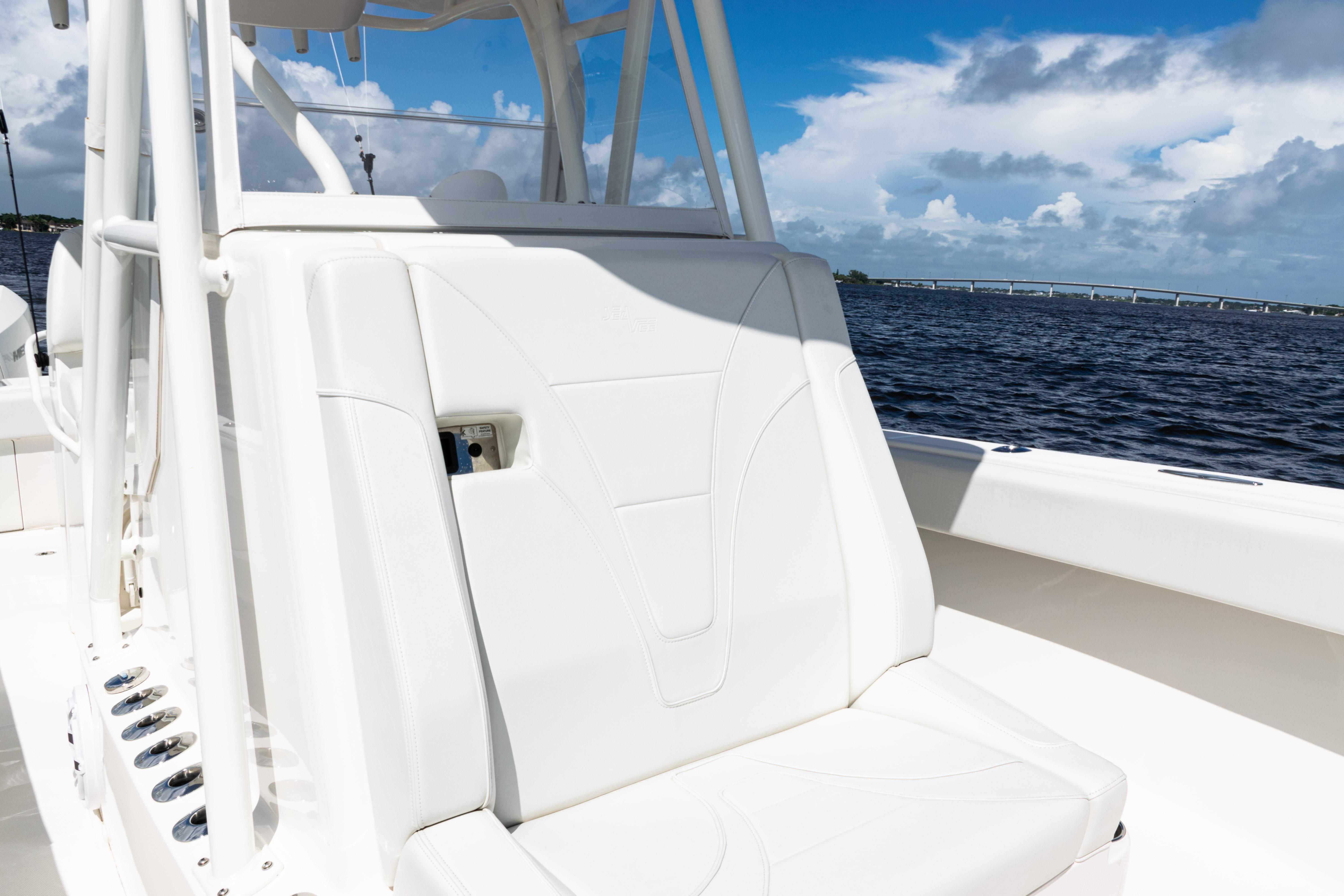 2023 SeaVee 340Z boat interior with white seating, ocean view, and blue sky.