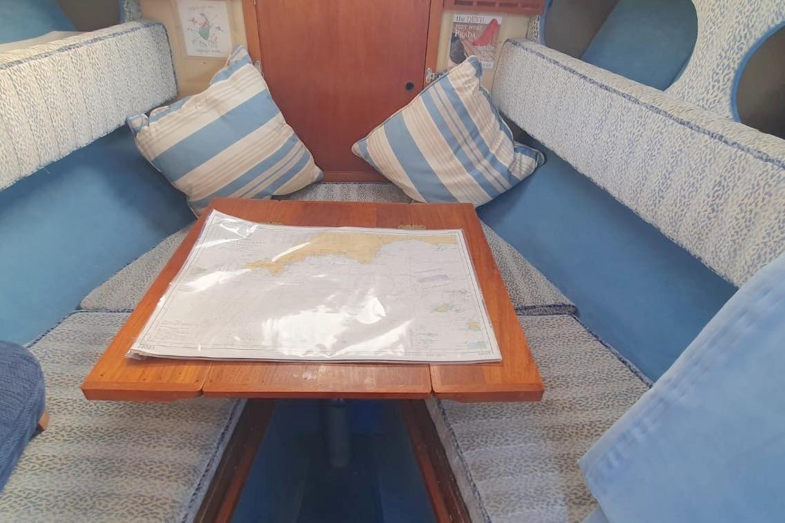 Cozy interior of 1989 Fairey Spearfish MKIII with nautical map on table.