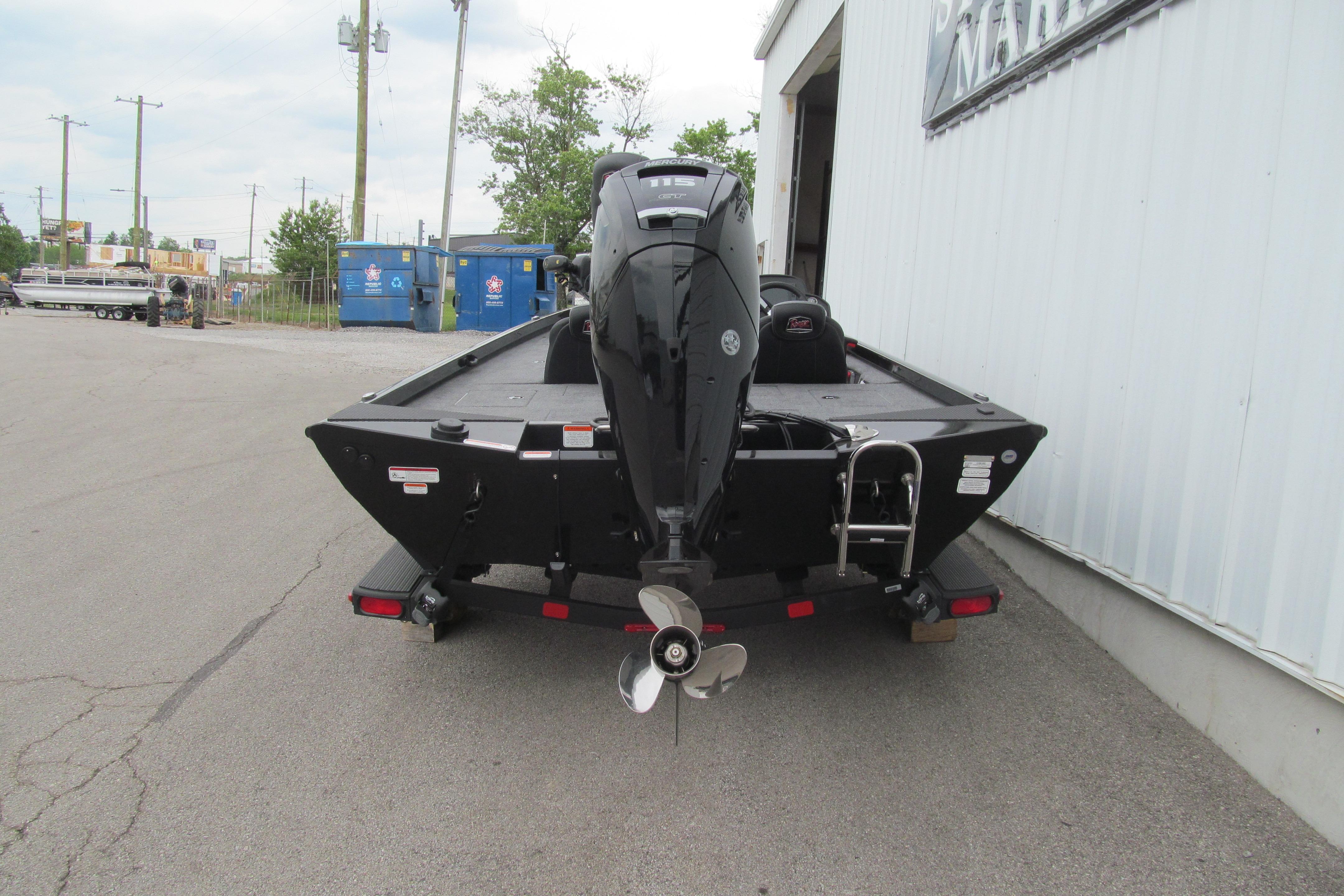 2026 Ranger RT188C boat with outboard motor, parked outside a building.