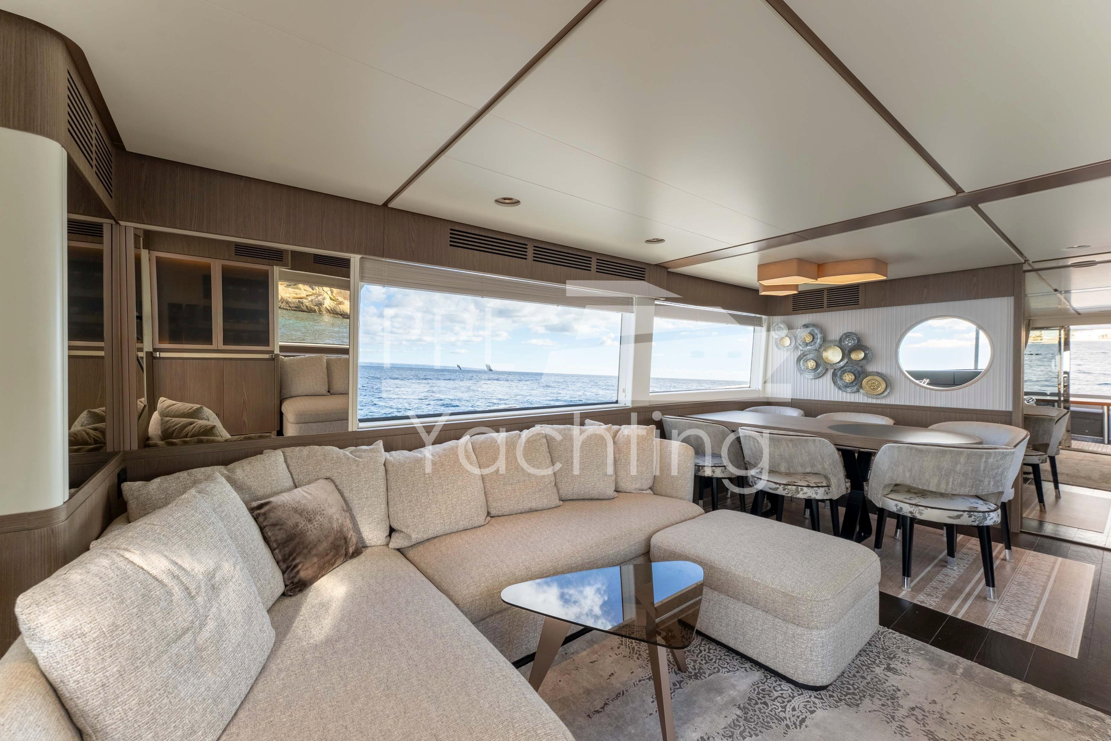 Luxurious interior of 2021 Azimut Magellano 66 yacht with elegant seating and ocean view.