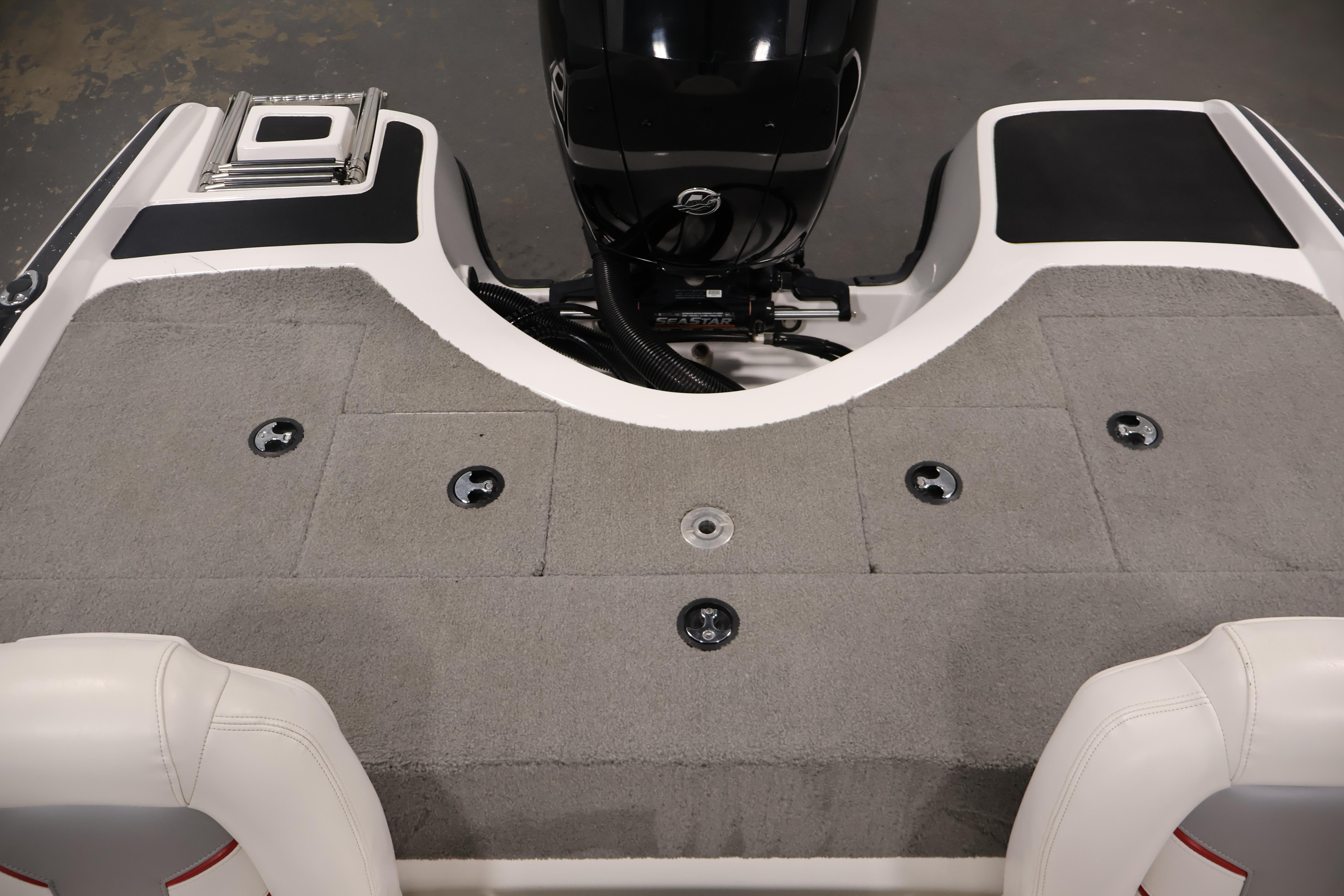 2019 Nitro Z19 Sport boat deck with carpeted surface and motor.