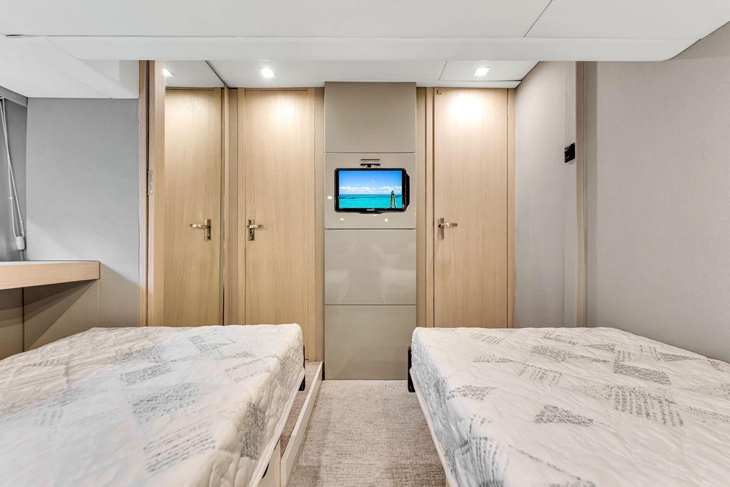 Luxurious twin cabin interior of 2012 Fairline Targa 58 yacht with modern decor.