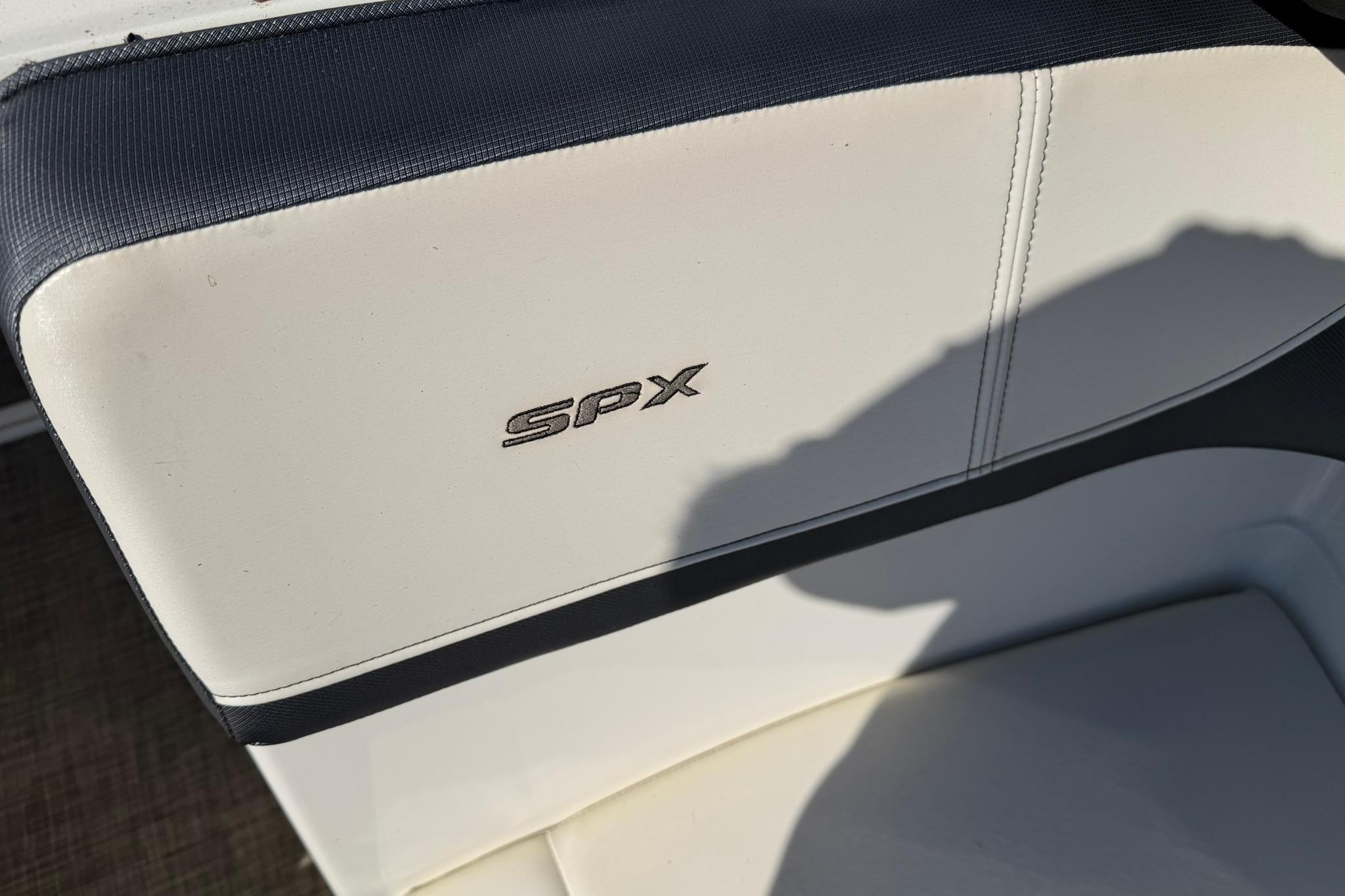 2016 Sea Ray SPX 210 boat seat with logo, featuring white and navy upholstery.