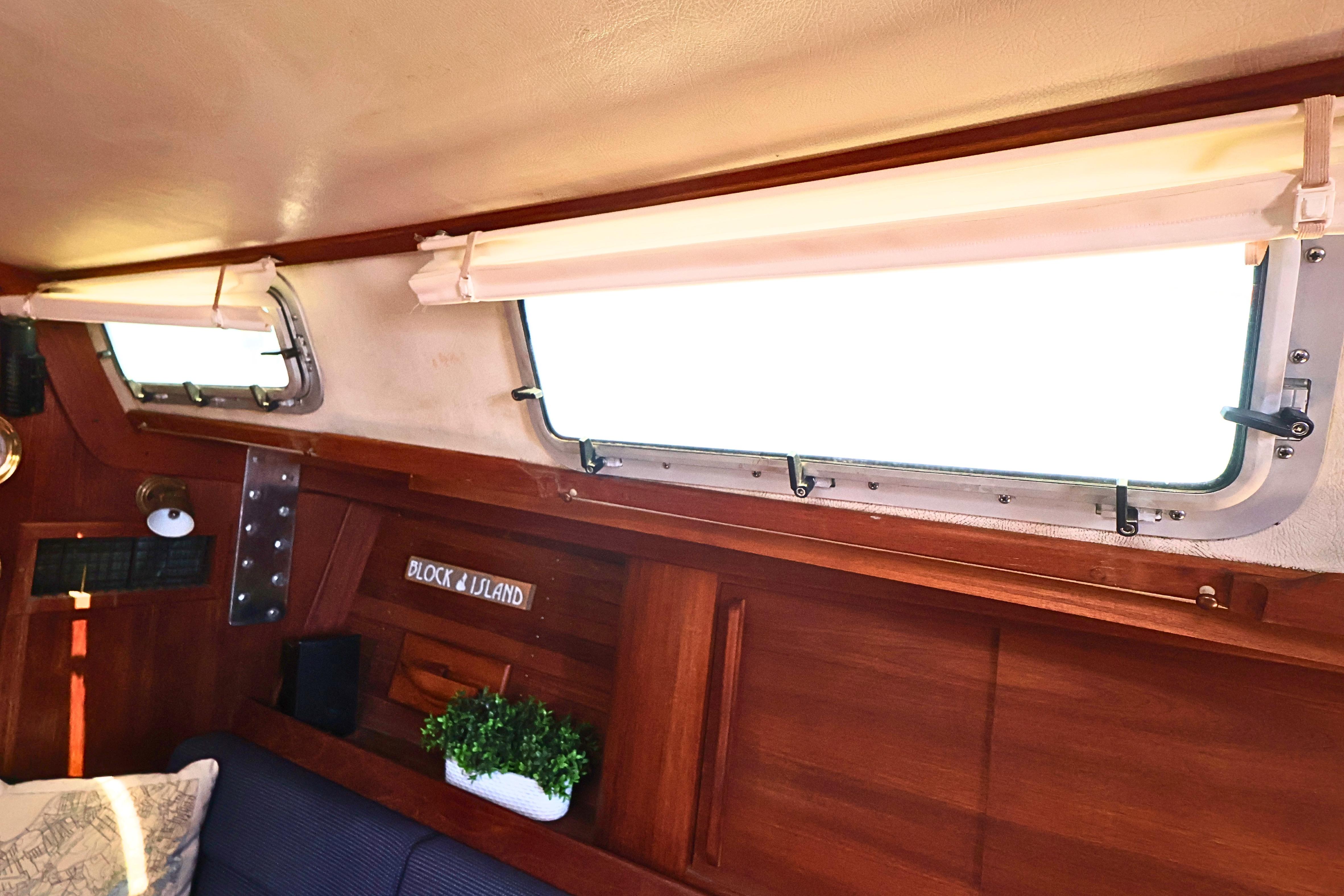 Interior of 1989 J Boat J 40 with wooden paneling and porthole windows.