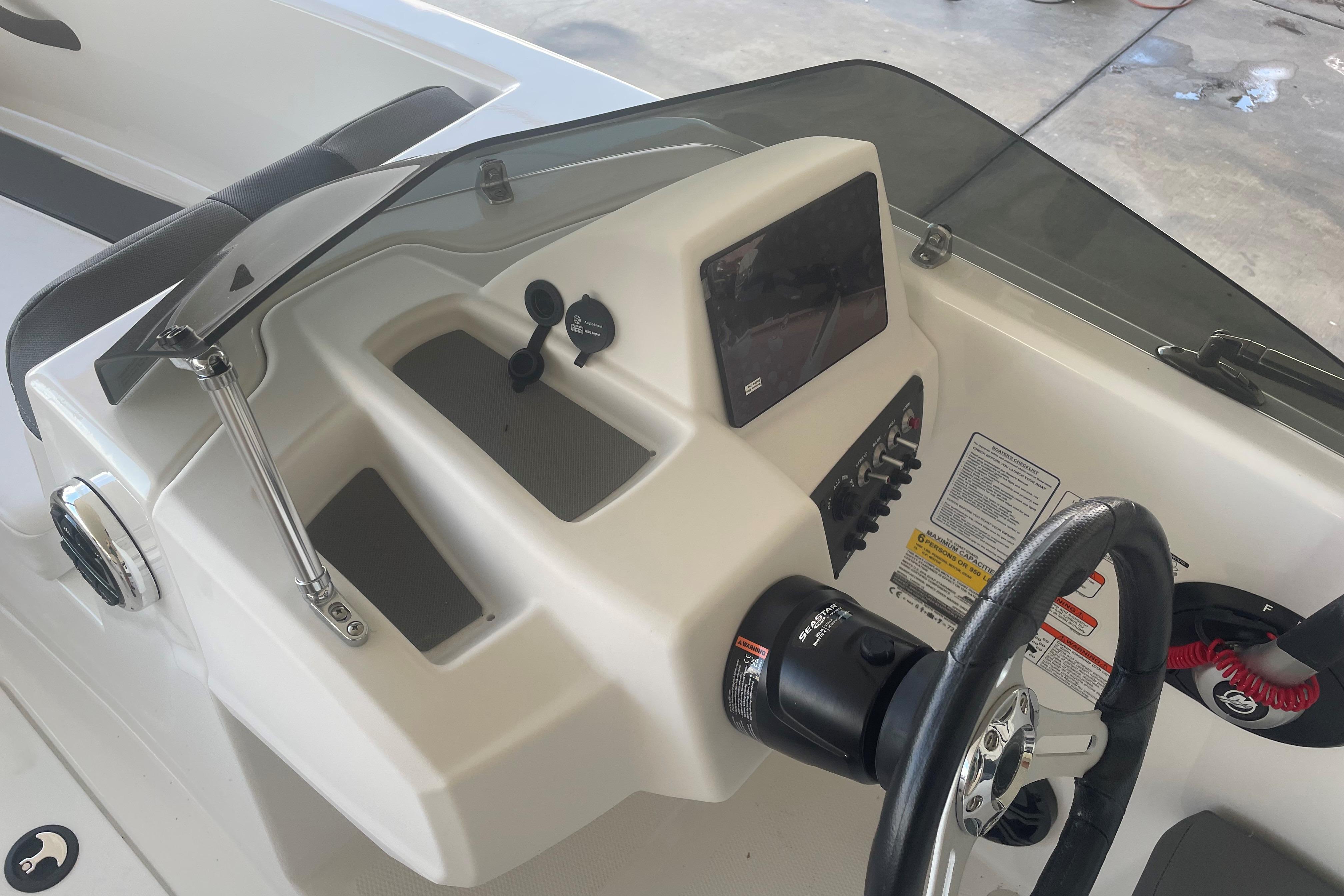 2026 Tahoe T16 boat dashboard with steering wheel, controls, and display screen.