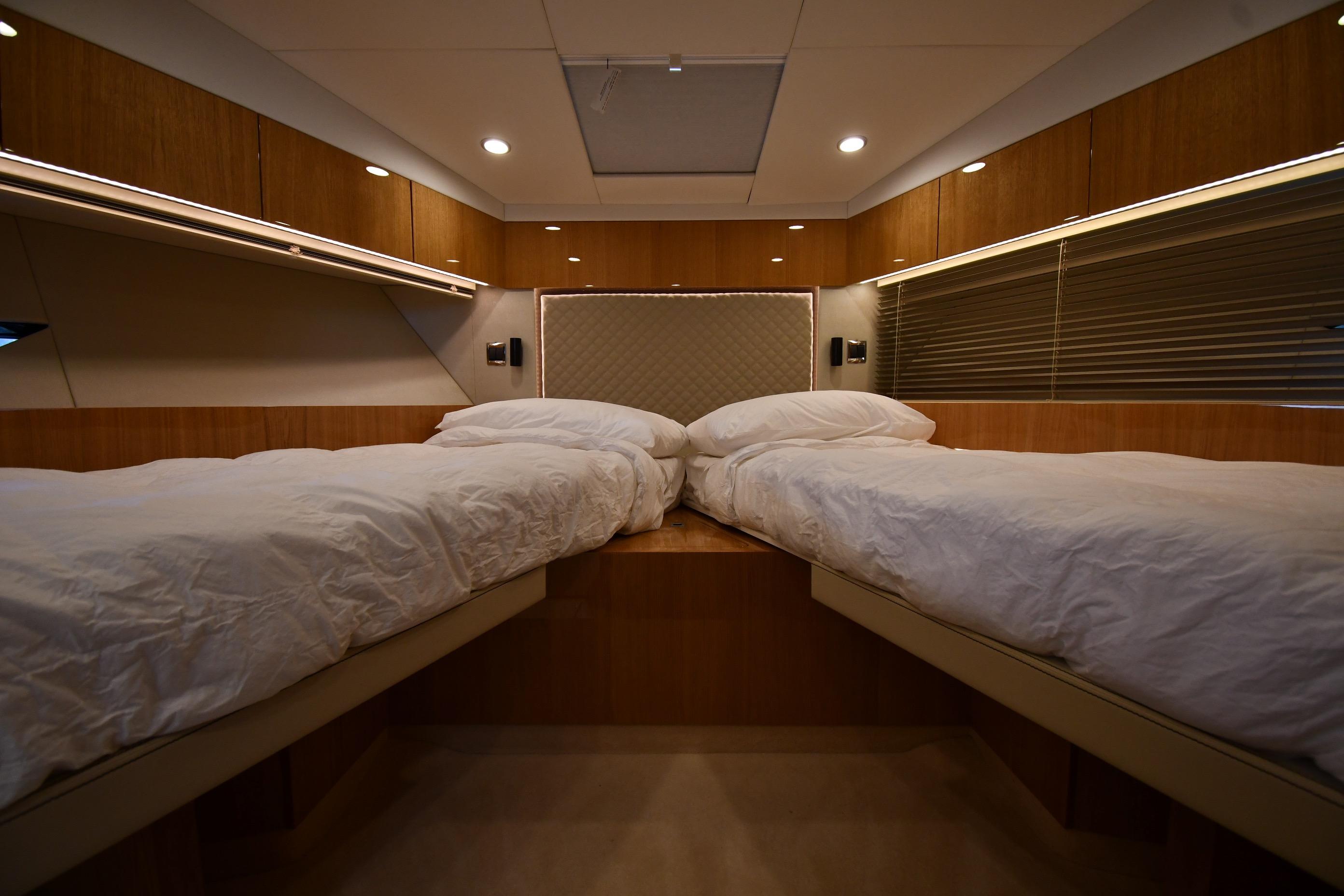 Luxurious twin cabin interior of 2024 Fairline G50 Targa yacht, featuring modern wood finishes.