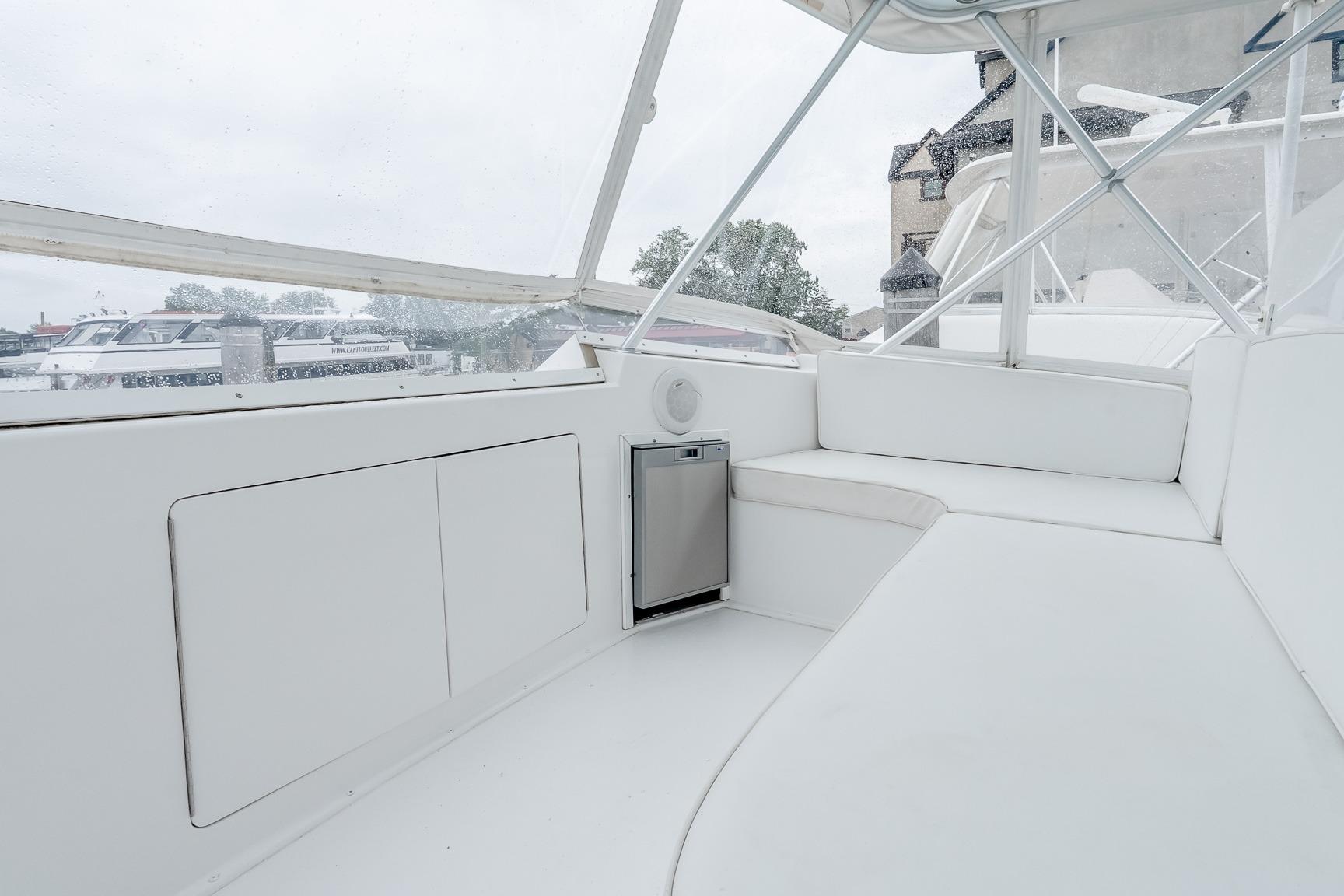 Interior view of a 2000 Viking 50' Convertible yacht with white seating and storage.