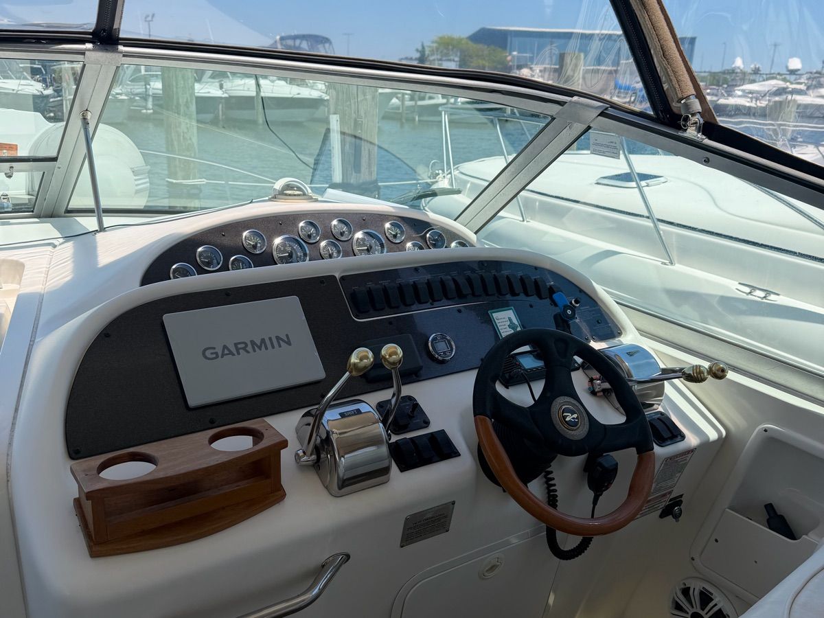 The cockpit of a 2001 Sea Ray Sundancer 310 with a Garmin navigation system.