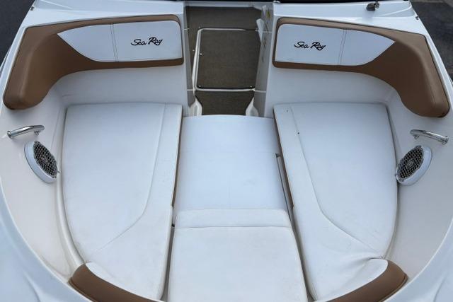 2017 Searay SPX210 boat interior with white and brown seating, featuring Sea Ray branding.