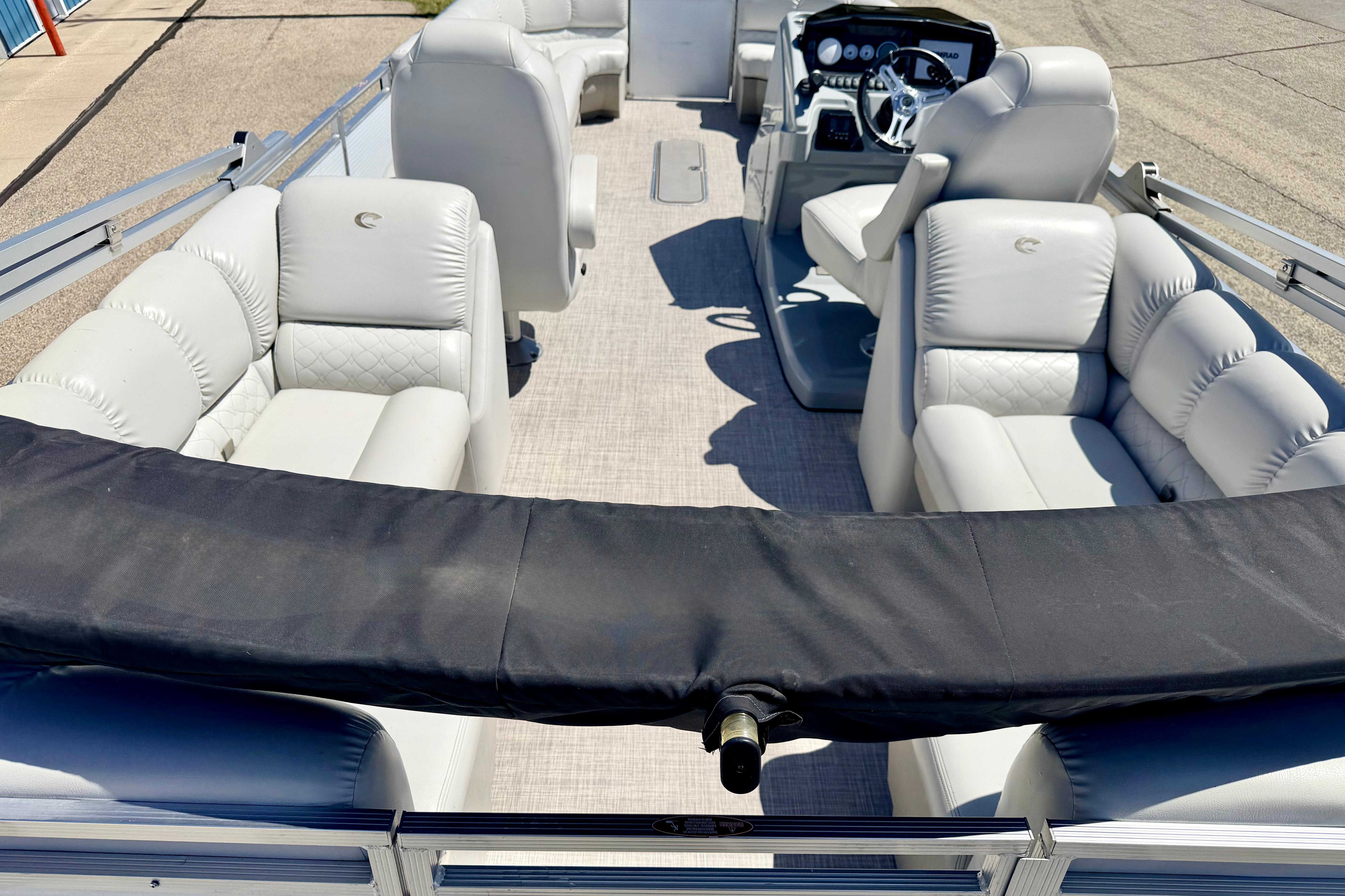 2019 Crestliner 240 Rally DX CW pontoon boat with plush seating and modern dashboard.