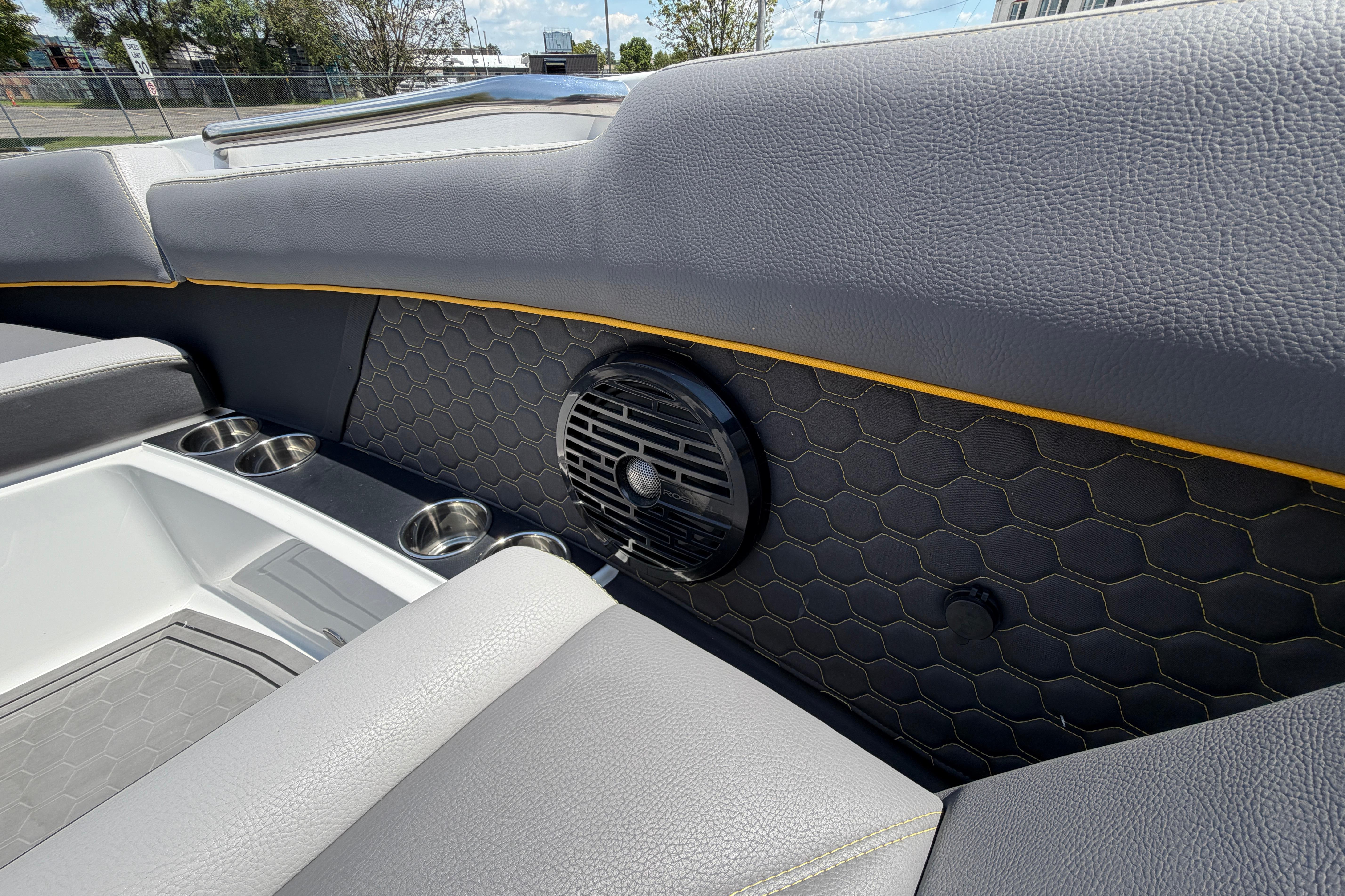 Interior of 2021 Cobalt R8 Surf boat with speaker and cup holders.