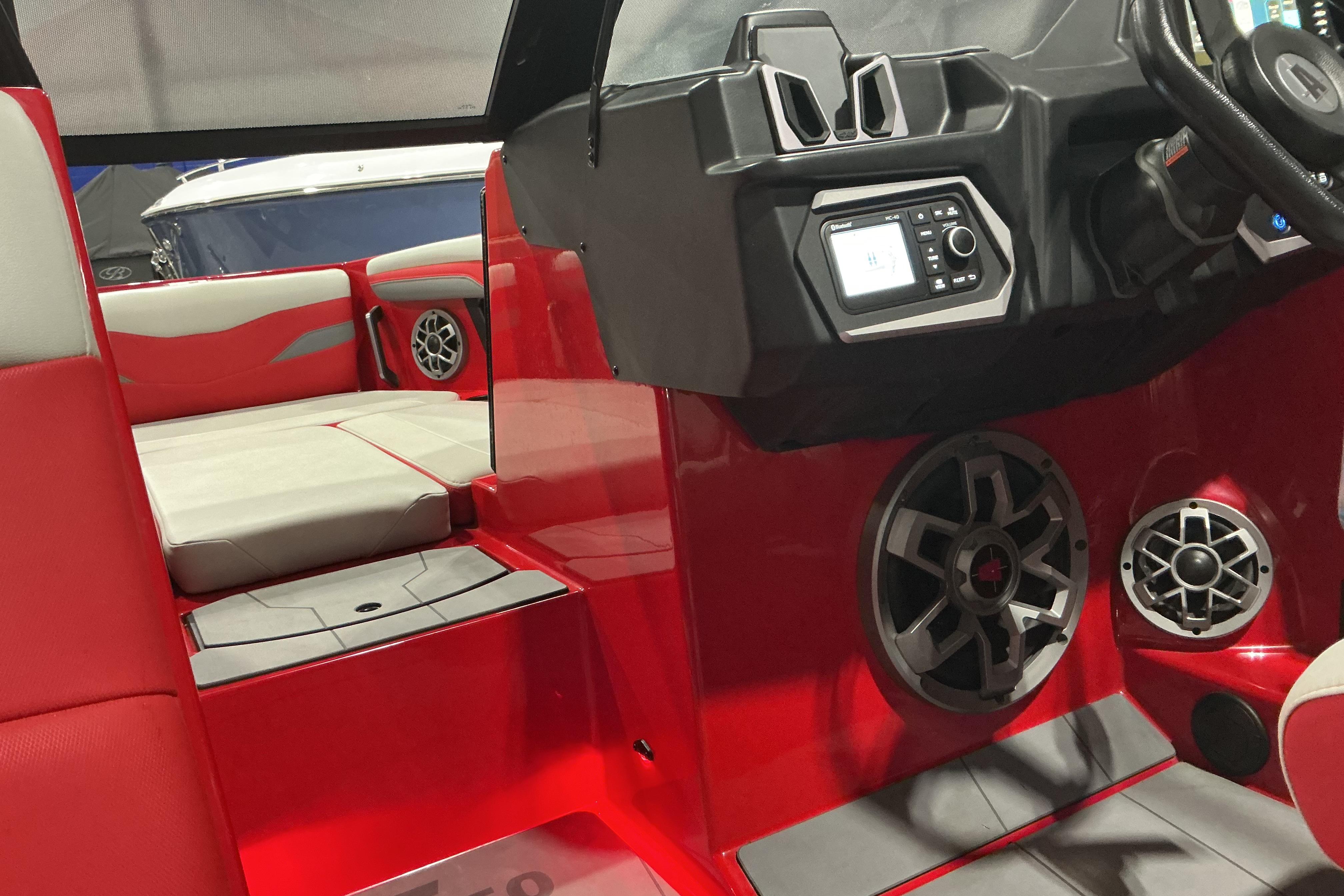 2022 Axis T250 boat interior with red and gray seating, speakers, and control panel.