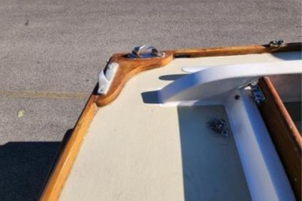 1985 Wasque Down East Cruiser boat deck with wooden trim and cleat.