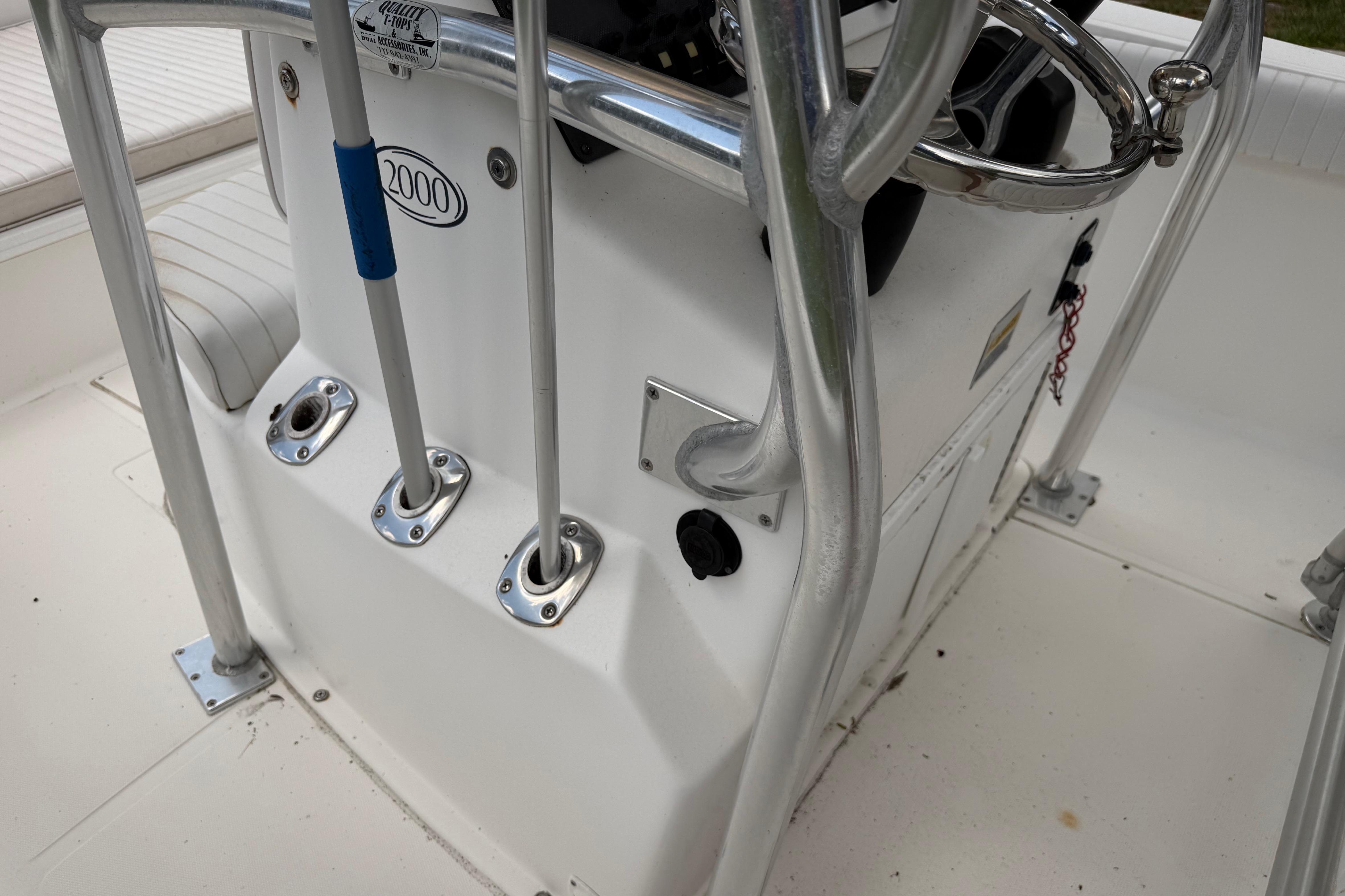Center console of a 2012 Clearwater 2000 boat with steering wheel and controls.