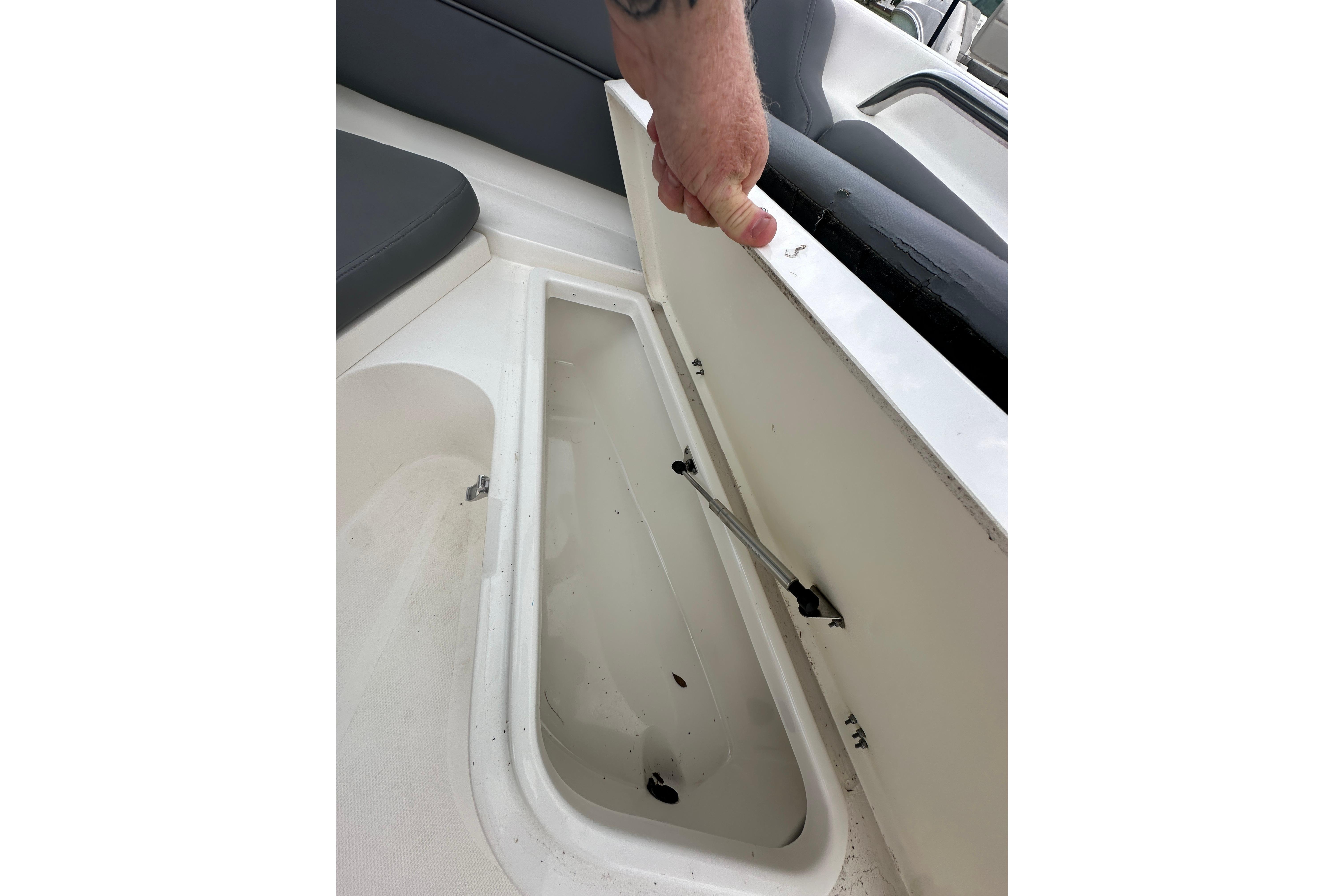 Open storage compartment on 2023 NauticStar 2102 Legacy boat, showcasing interior space.