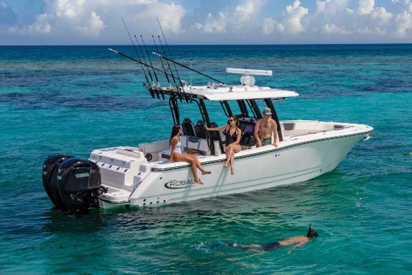 Manufacturer Provided Image: 2025 Robalo R300 Center Console boat with people relaxing and snorkeling in clear blue water.