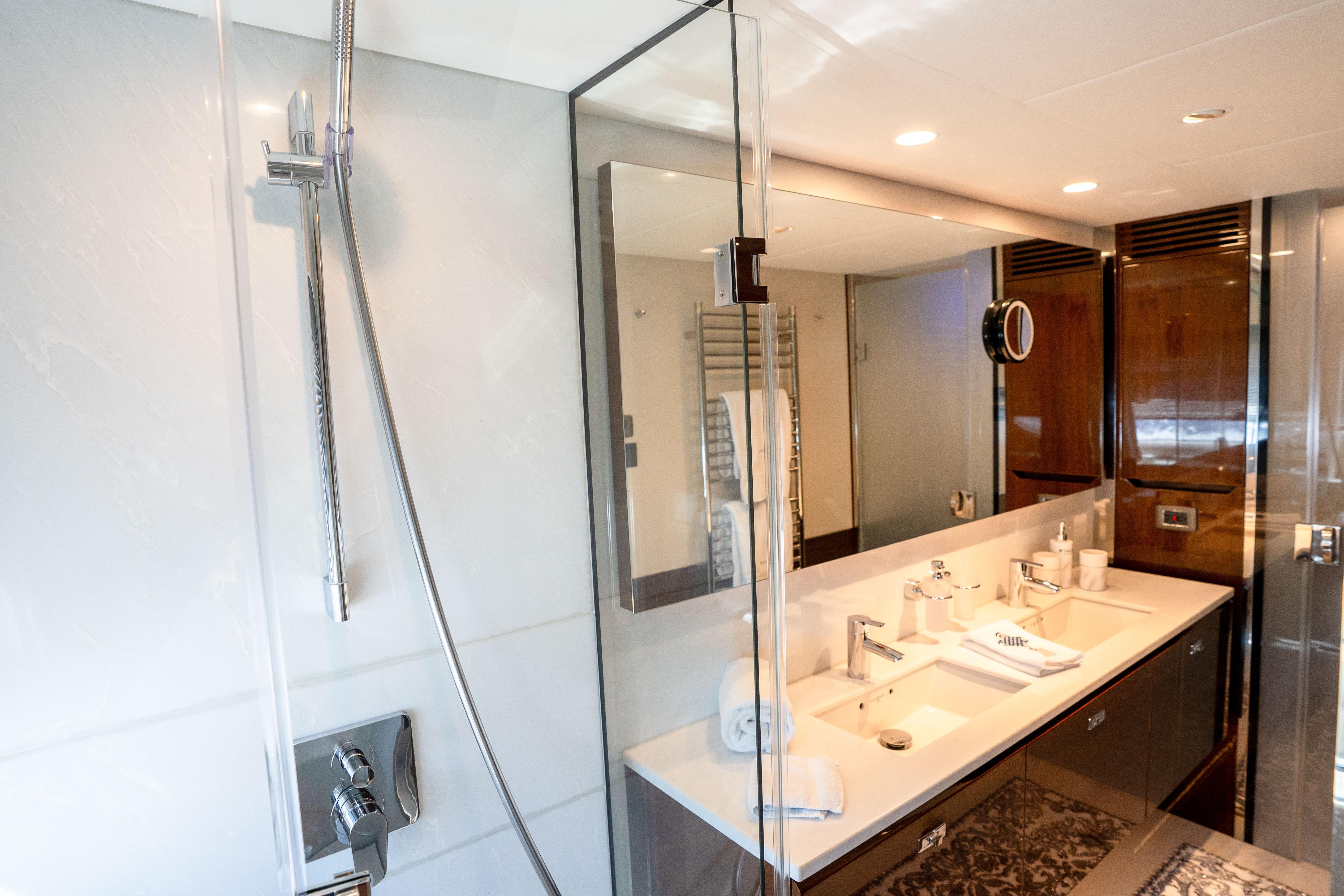 Luxurious bathroom in 2020 Princess Y85 yacht with dual sinks and modern shower.