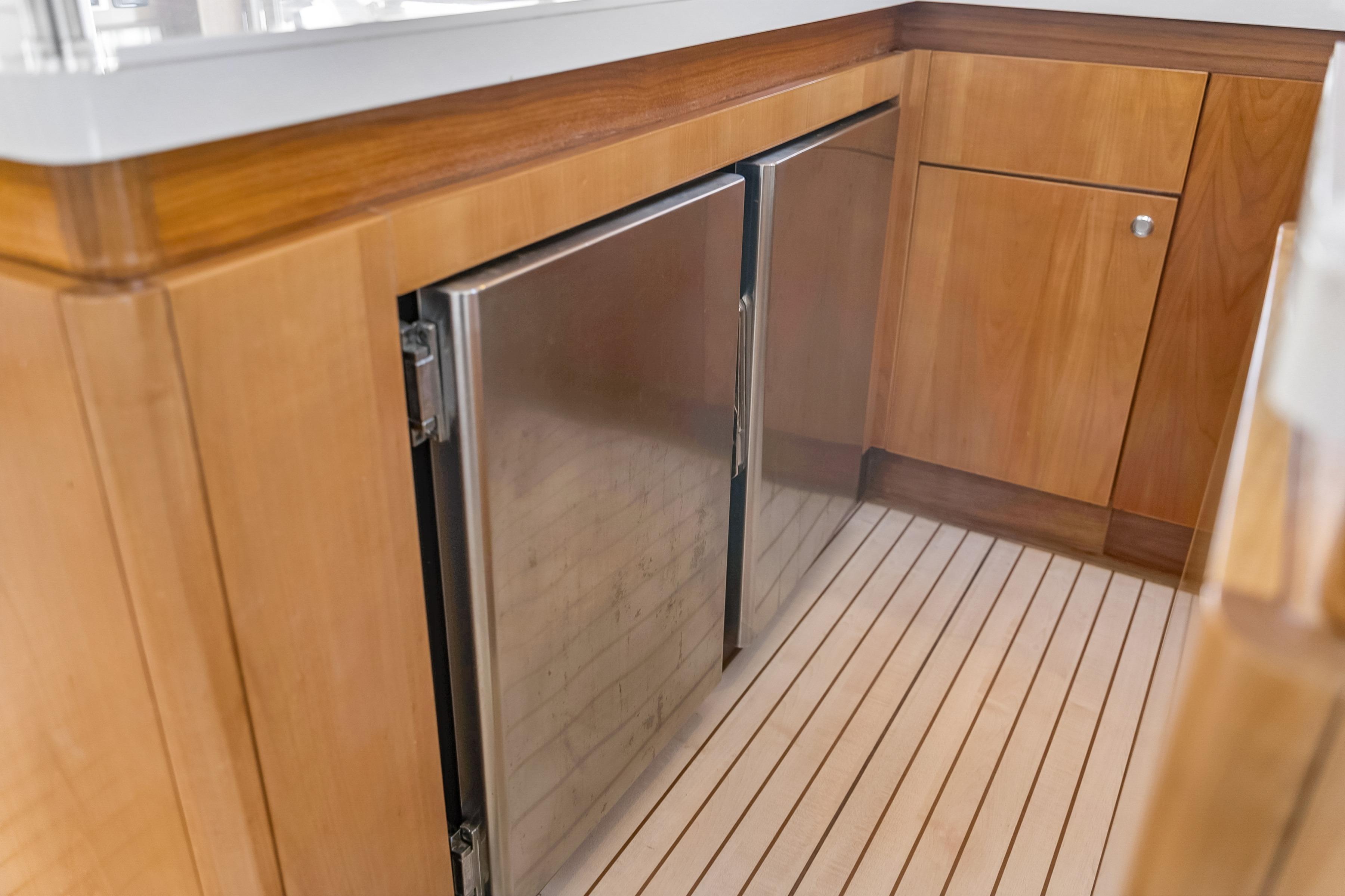 Wooden yacht interior with stainless steel fridge, Catana 65, 2009 model.