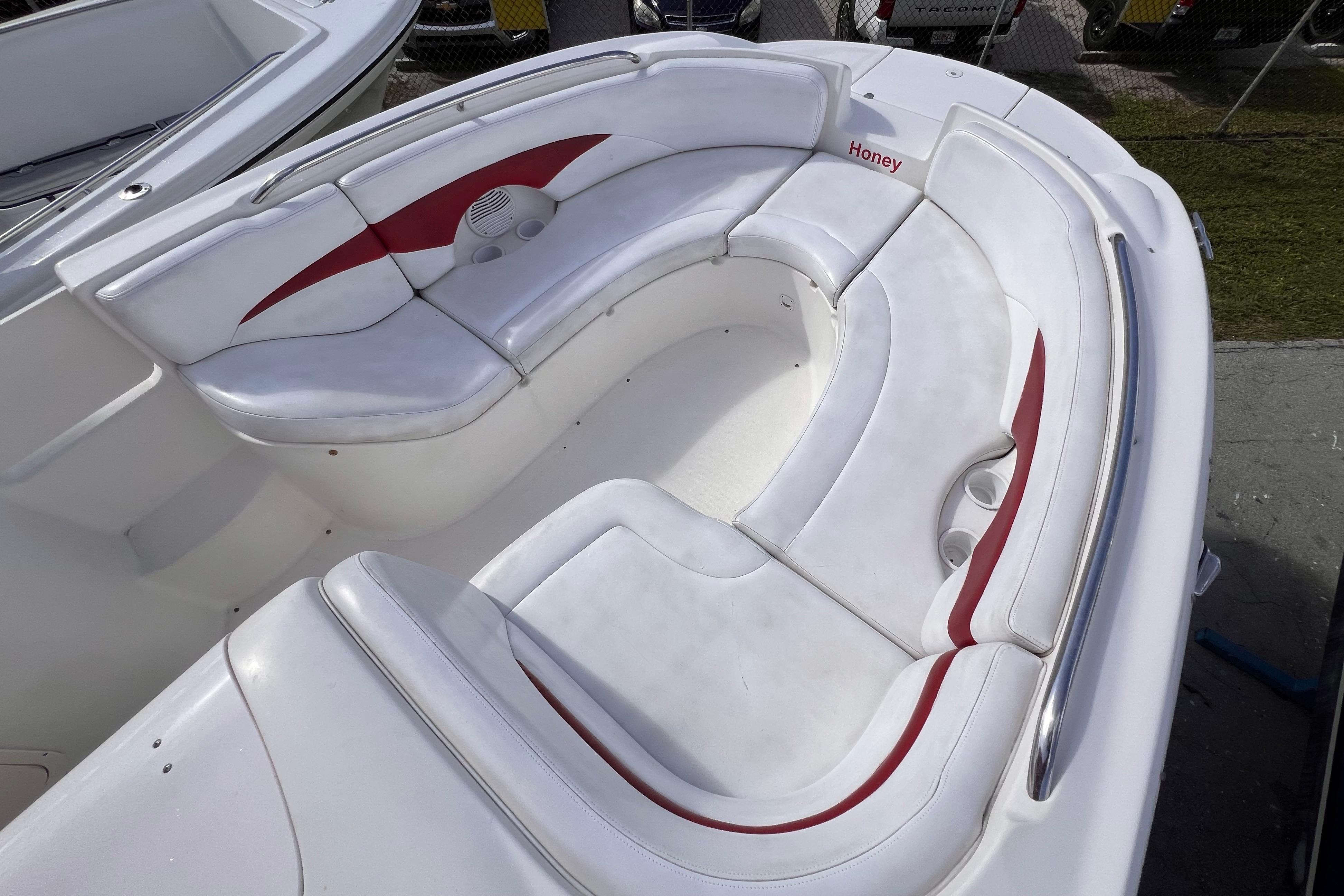 2002 Chaparral 232 Sunesta boat interior with white and red seating.