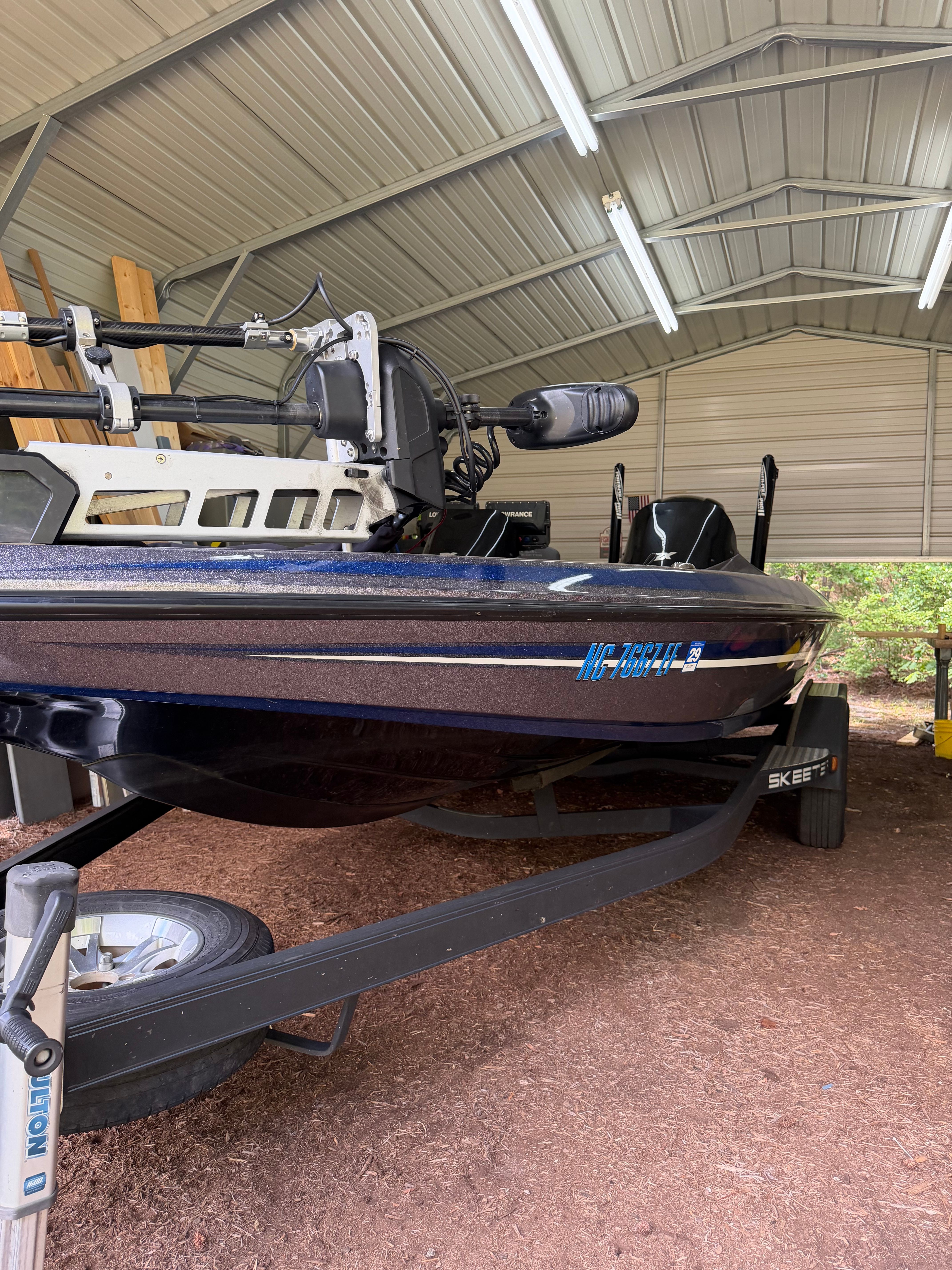 A 2017 Skeeter ZX250 boat is on a trailer in a covered area.
