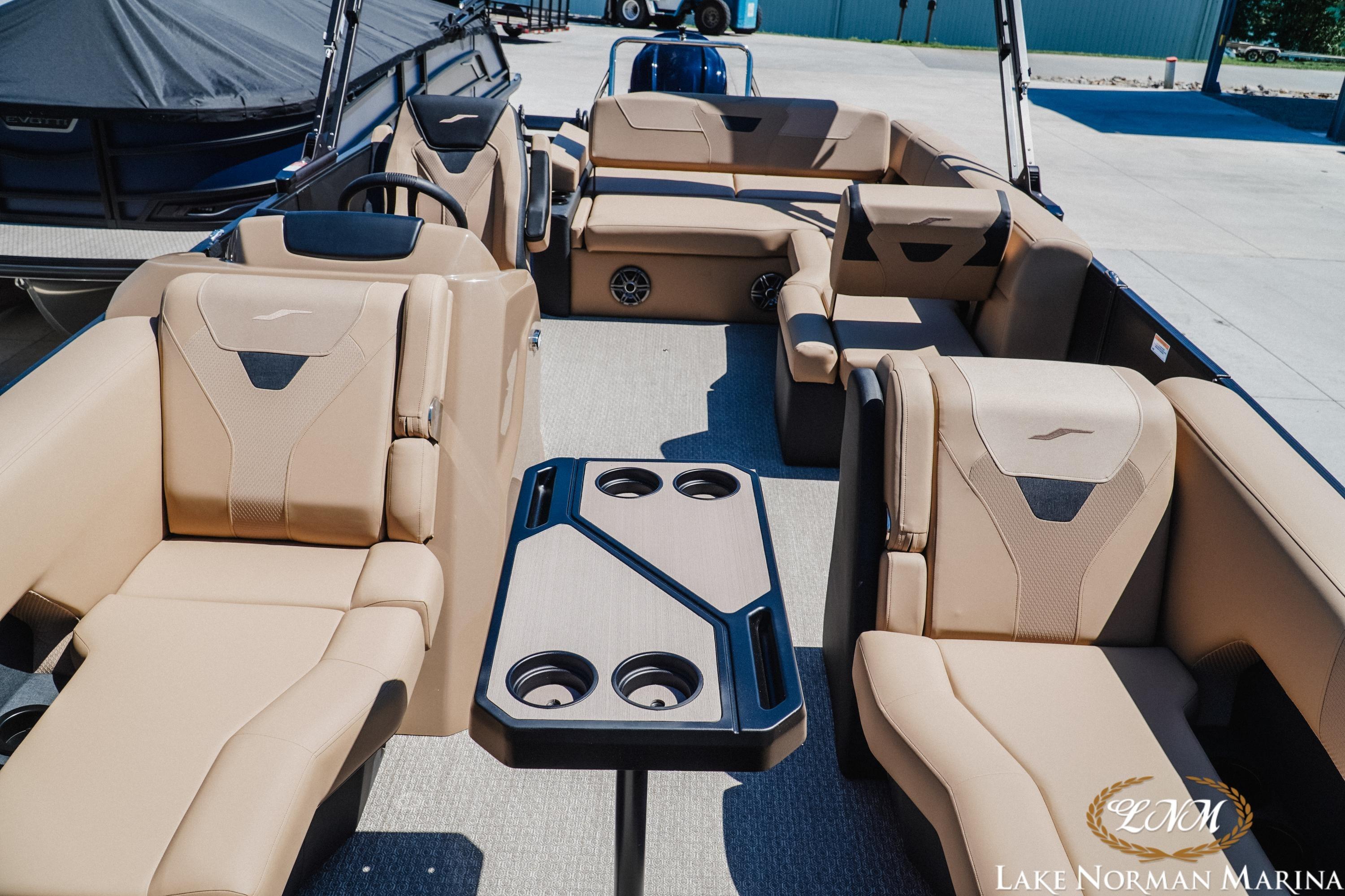 Luxurious interior of 2026 Evotti 523CS boat at Lake Norman Marina, featuring plush seating and table.