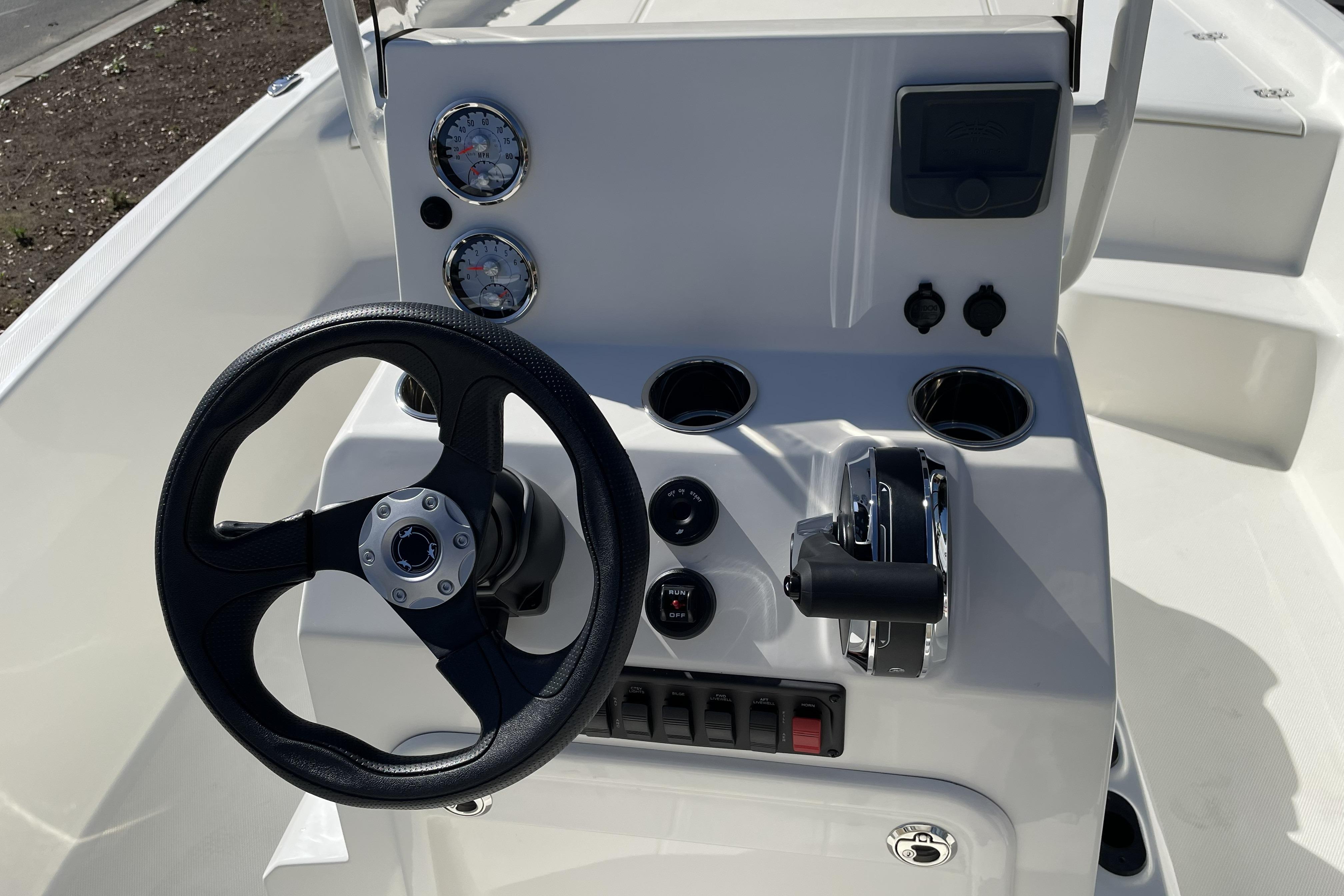 Steering console of 2026 Mako Pro Skiff 19 CC with gauges and controls.