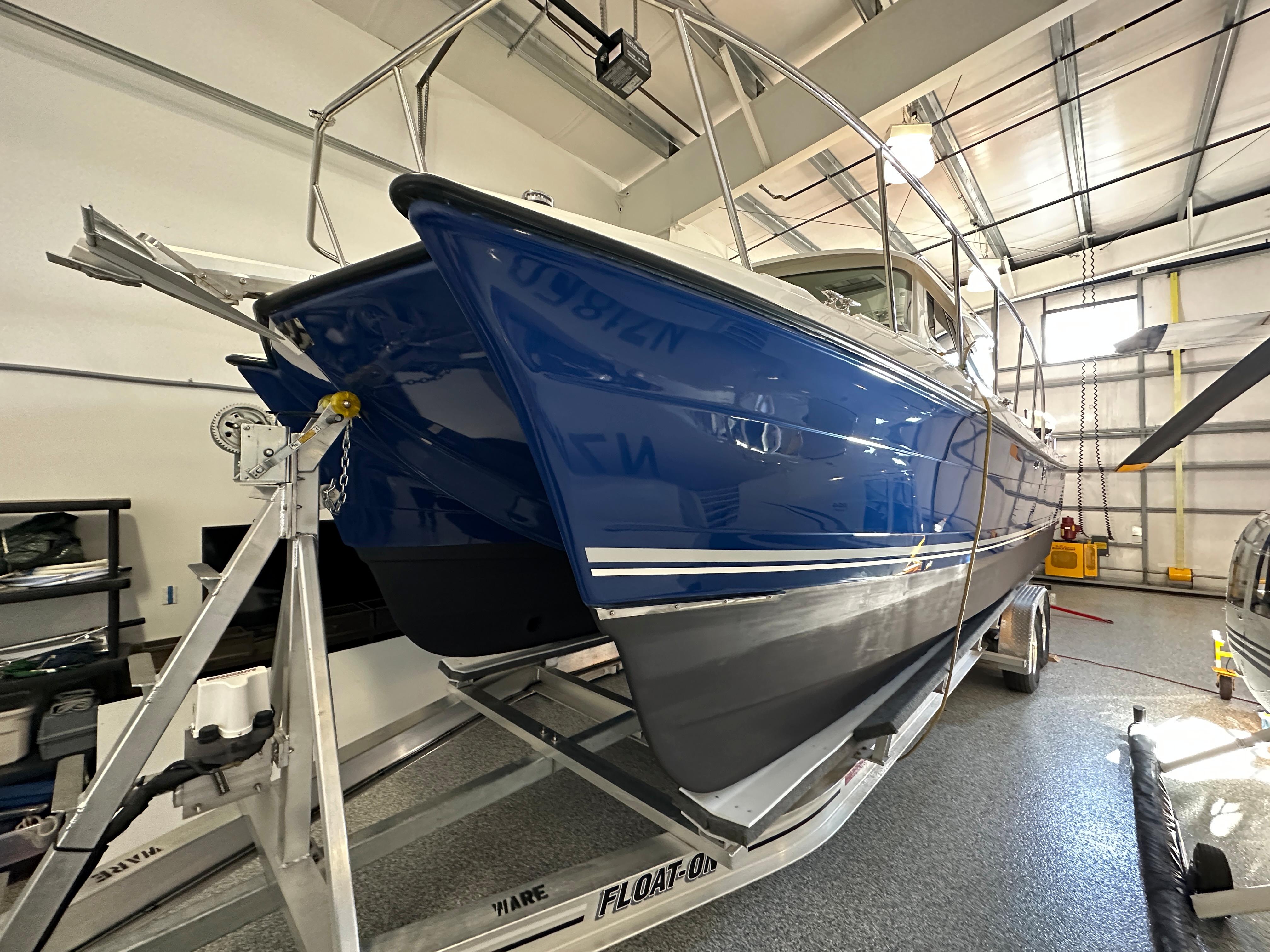 2016 Aspen C100 boat in a garage on a trailer.