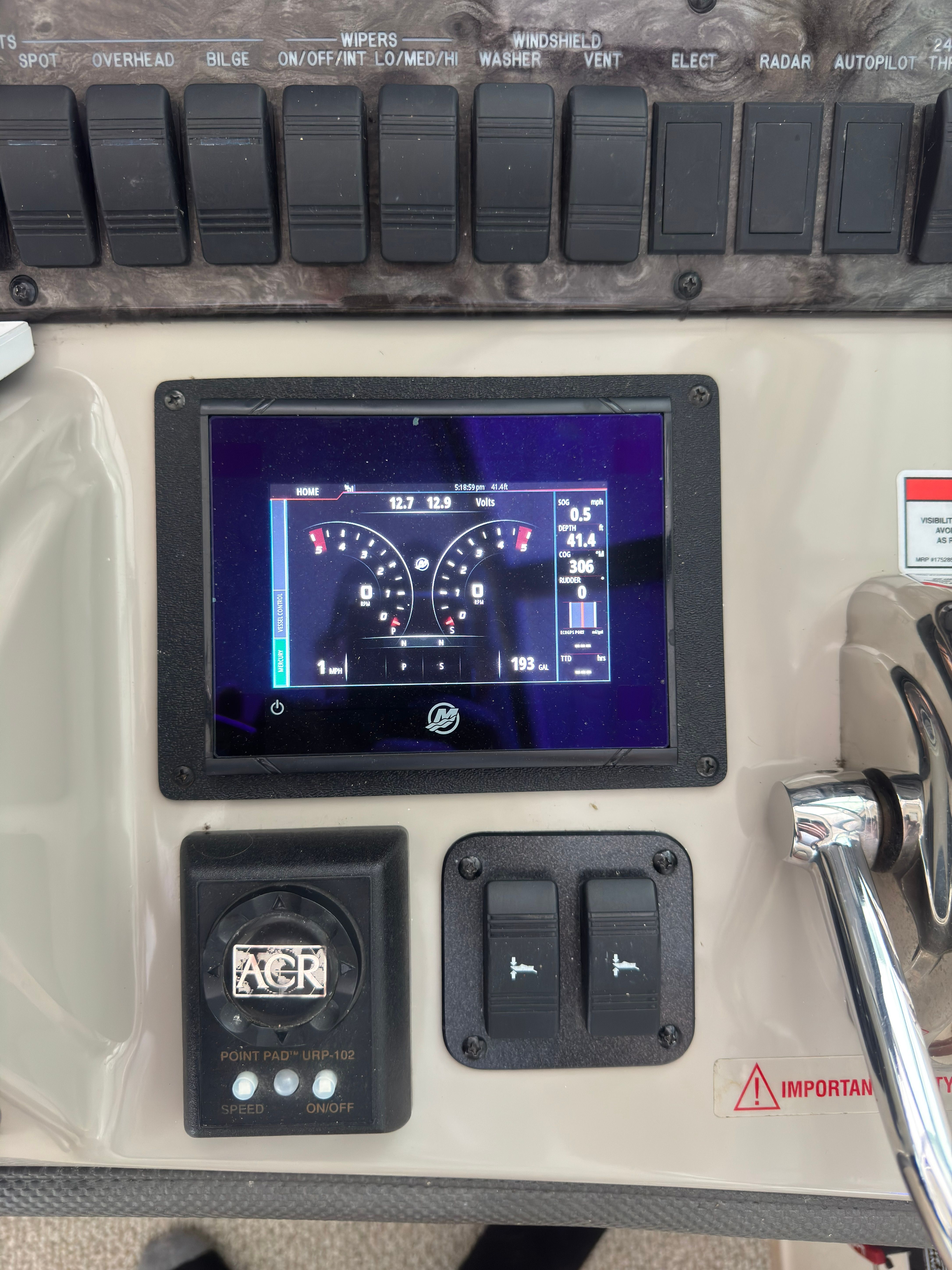 Dashboard with screen and switches on a Sea Ray 40 Sundancer boat.