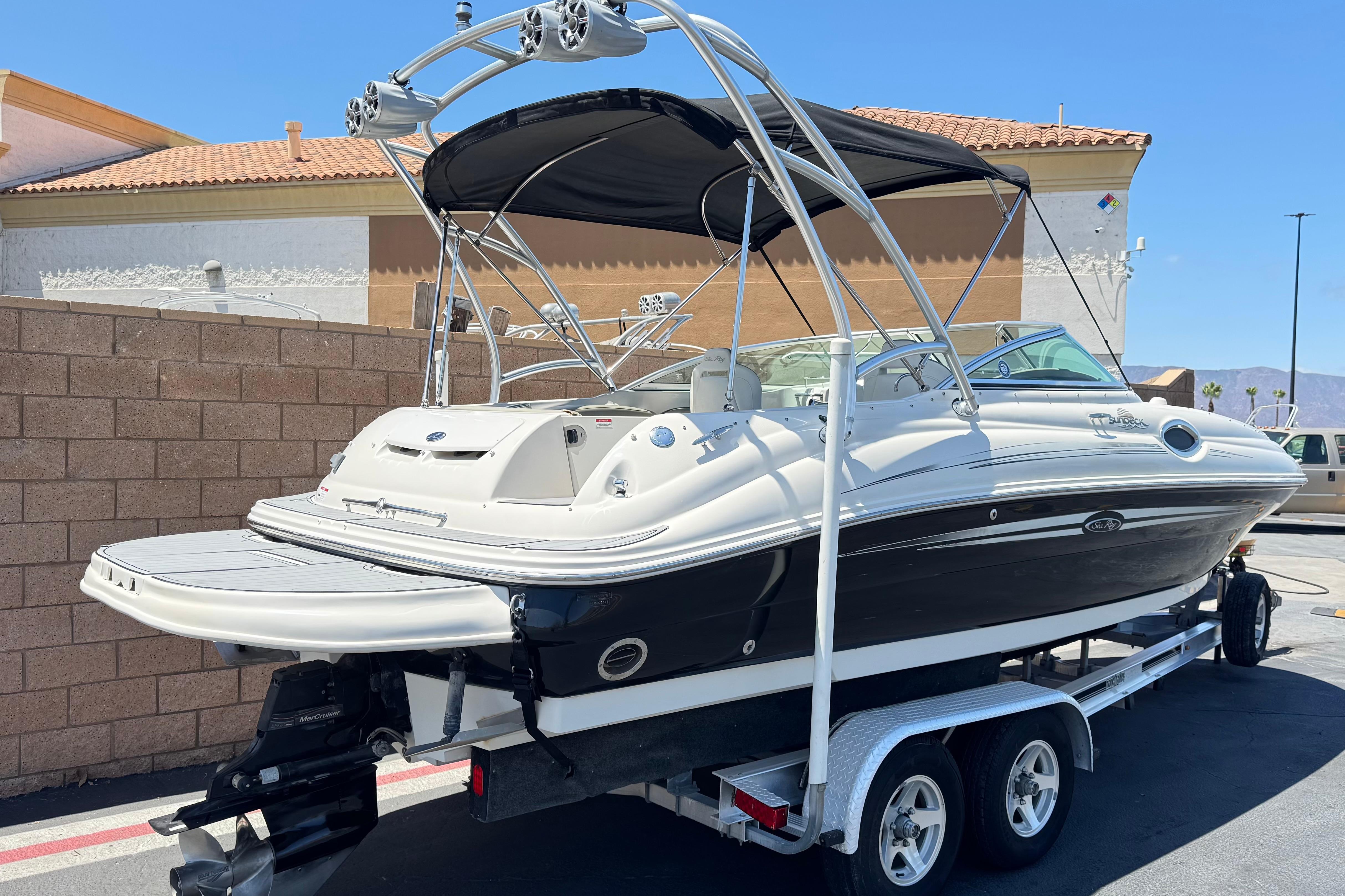 2007 Sea Ray 240 Sundeck boat on trailer, featuring sleek design and black hull.