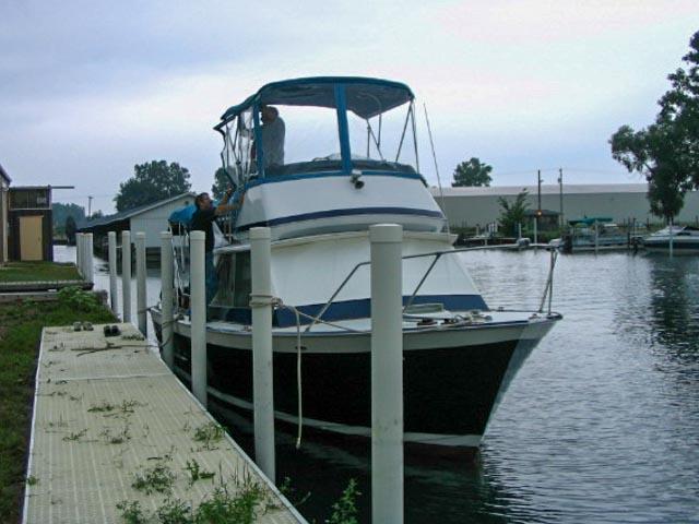 1967 Chris-Craft Sea Skiff 32 Sport Cruiser docked at a marina.