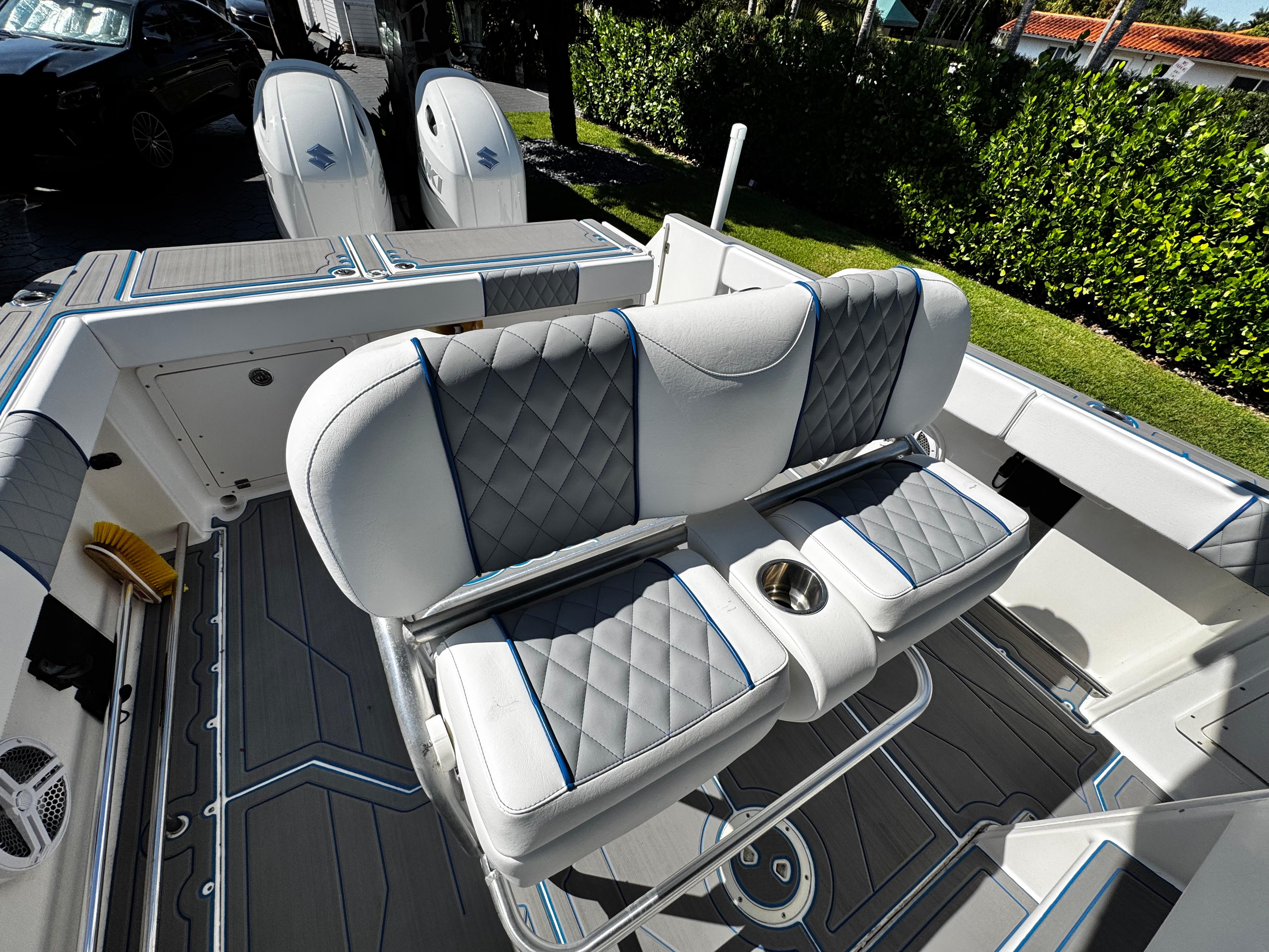 2004 Robalo R 260 boat interior with cushioned seating and dual outboard motors.