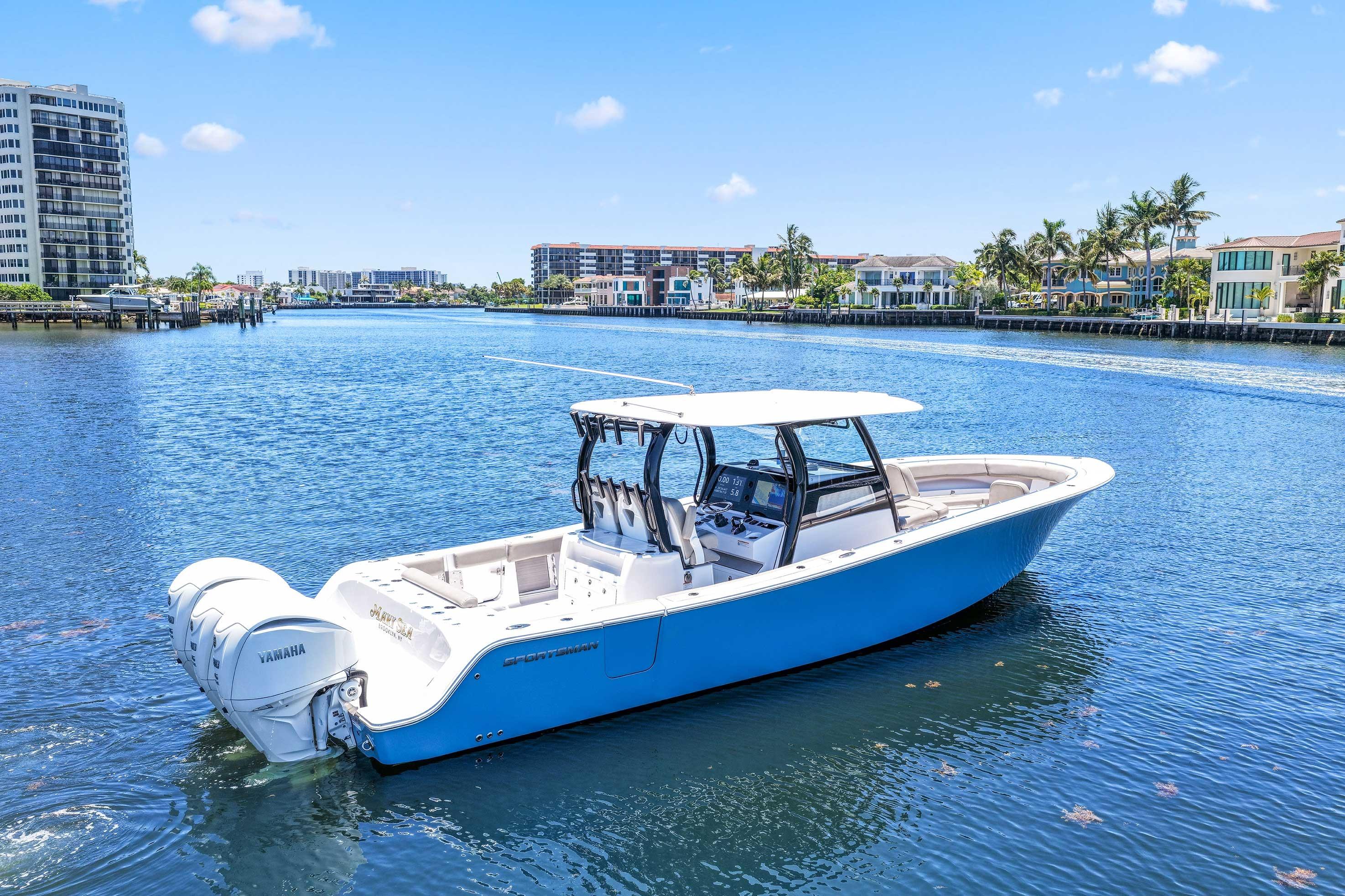 2024 Sportsman Open 352 Center Console boat on a sunny waterfront.