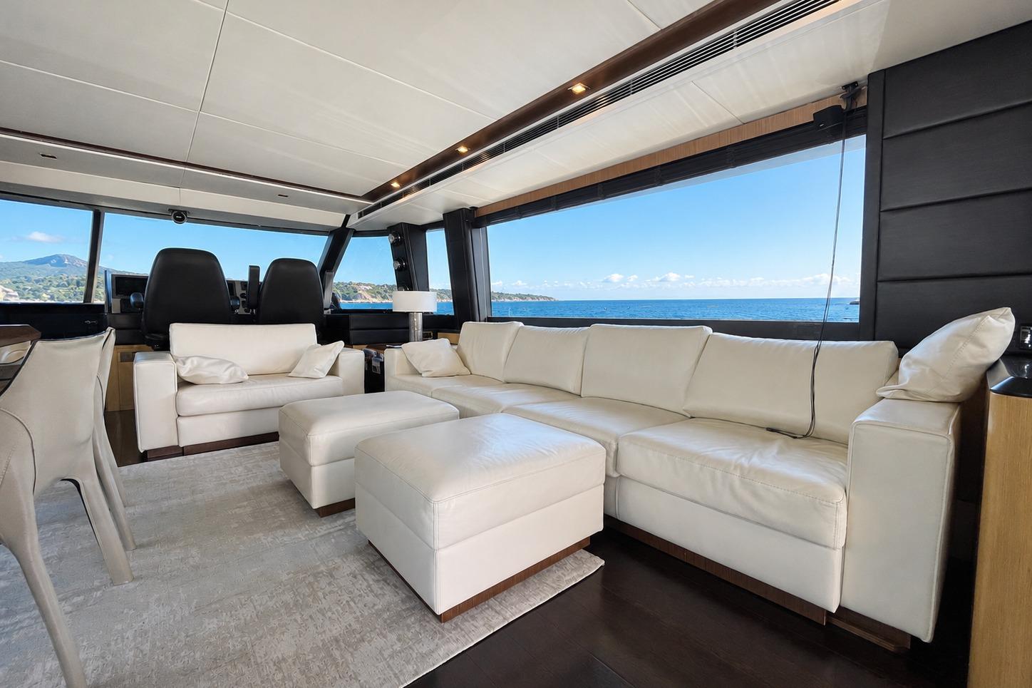 Luxurious interior of 2012 Azimut Magellano 74 yacht with white leather seating and ocean view.