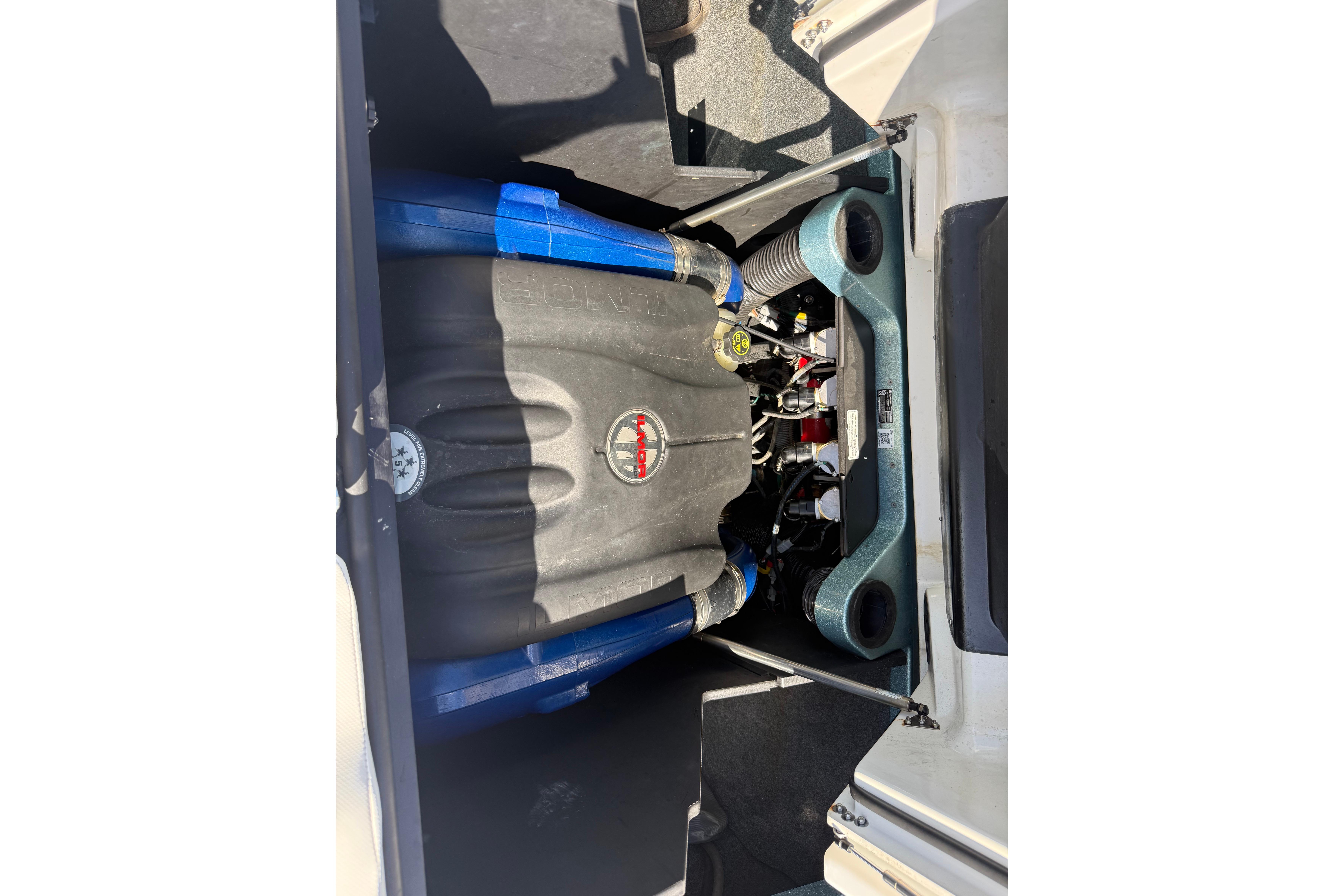 2023 MasterCraft X24 engine compartment with blue hoses and Indmar branding.