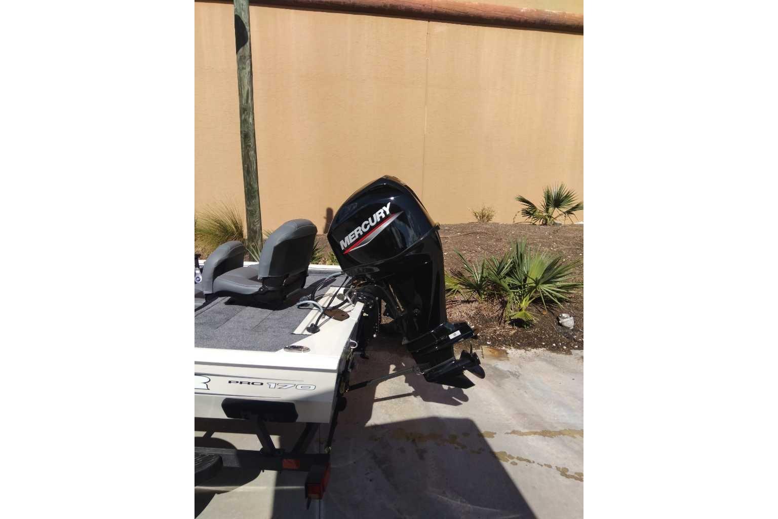 2026 Tracker Pro 170 boat with Mercury outboard motor, parked outdoors.