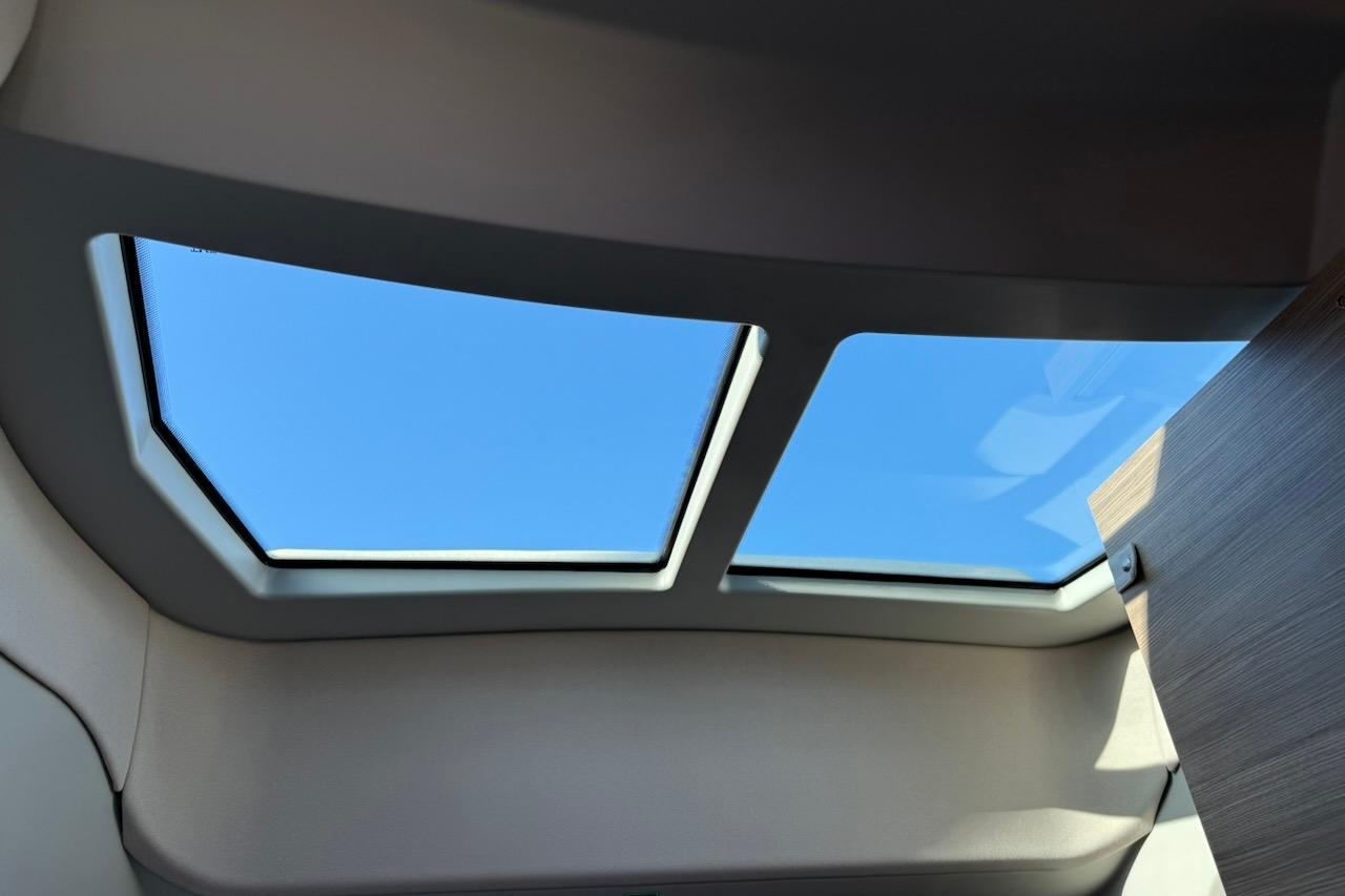 2024 Saxdor 320 GTC interior skylight view with clear blue sky.