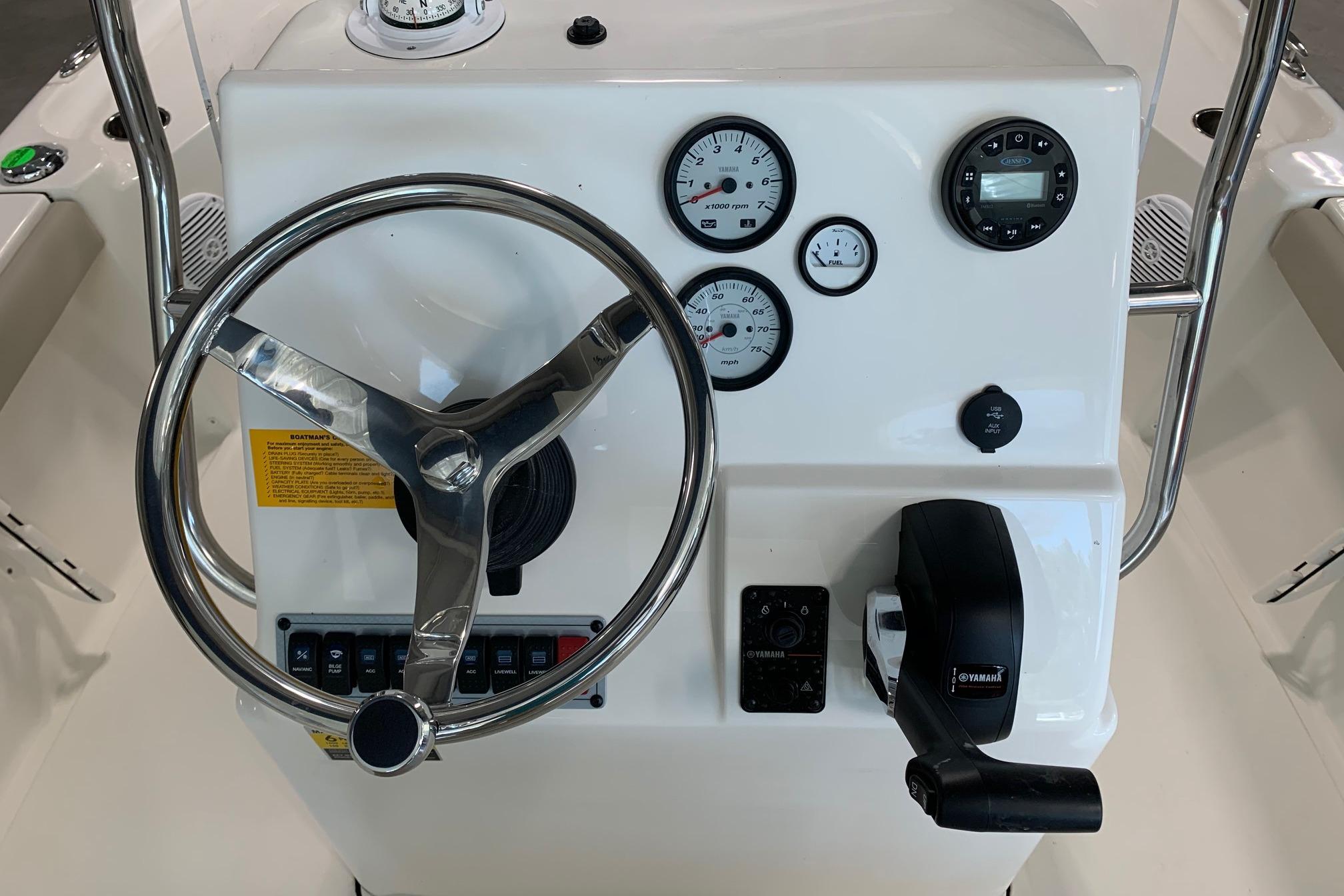 Steering console of 2026 Key West 188 Bay Reef boat with gauges and controls.