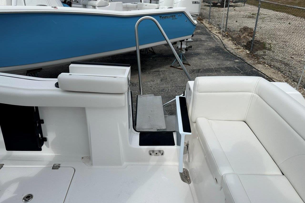 2026 Tidewater 272 LXF boat interior with white seating and swim platform.