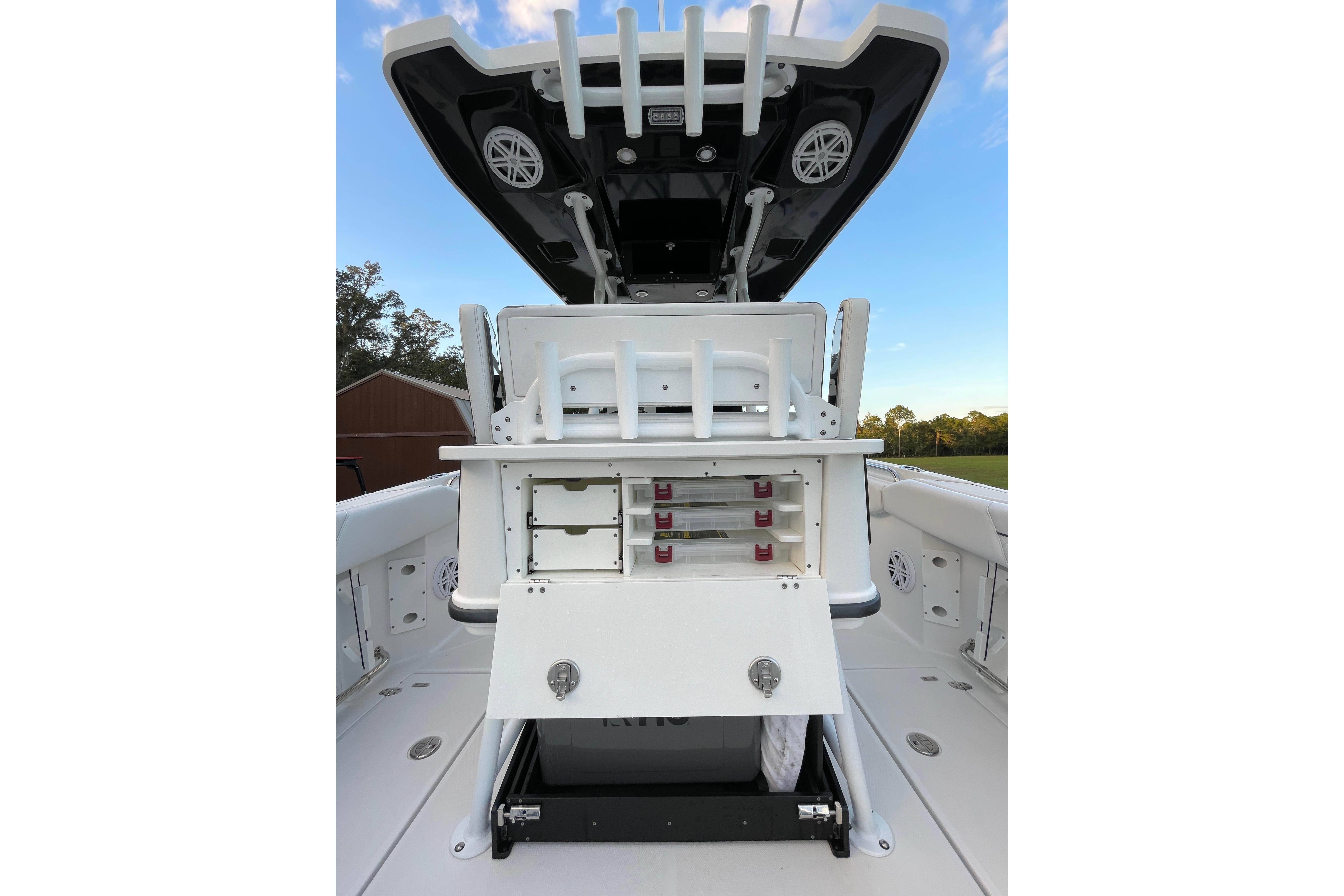 2022 Blackfin 252 CC boat with open storage compartments and rod holders.