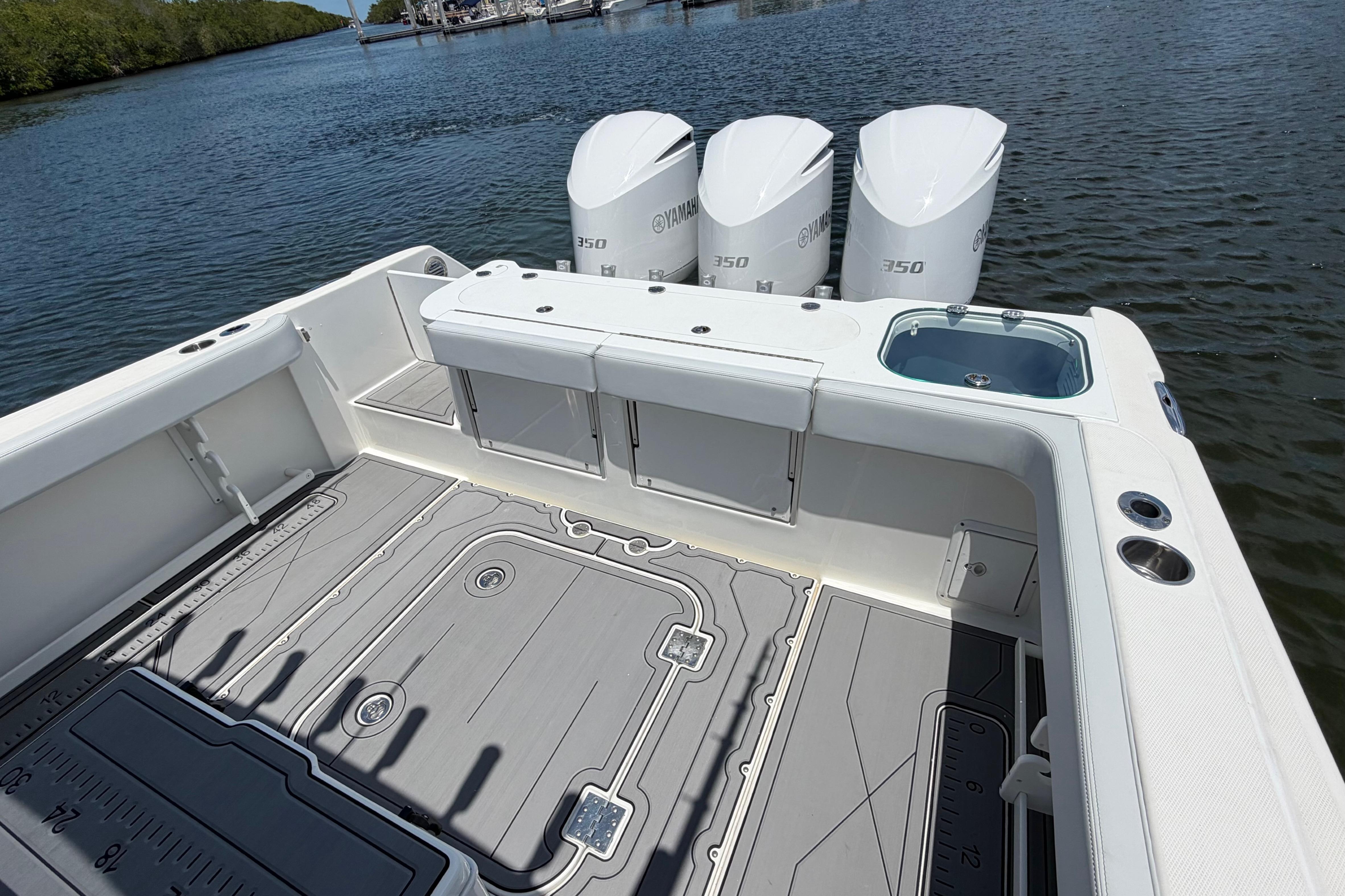 2009 Everglades 350LX boat with triple Yamaha 350 engines on a calm waterway.