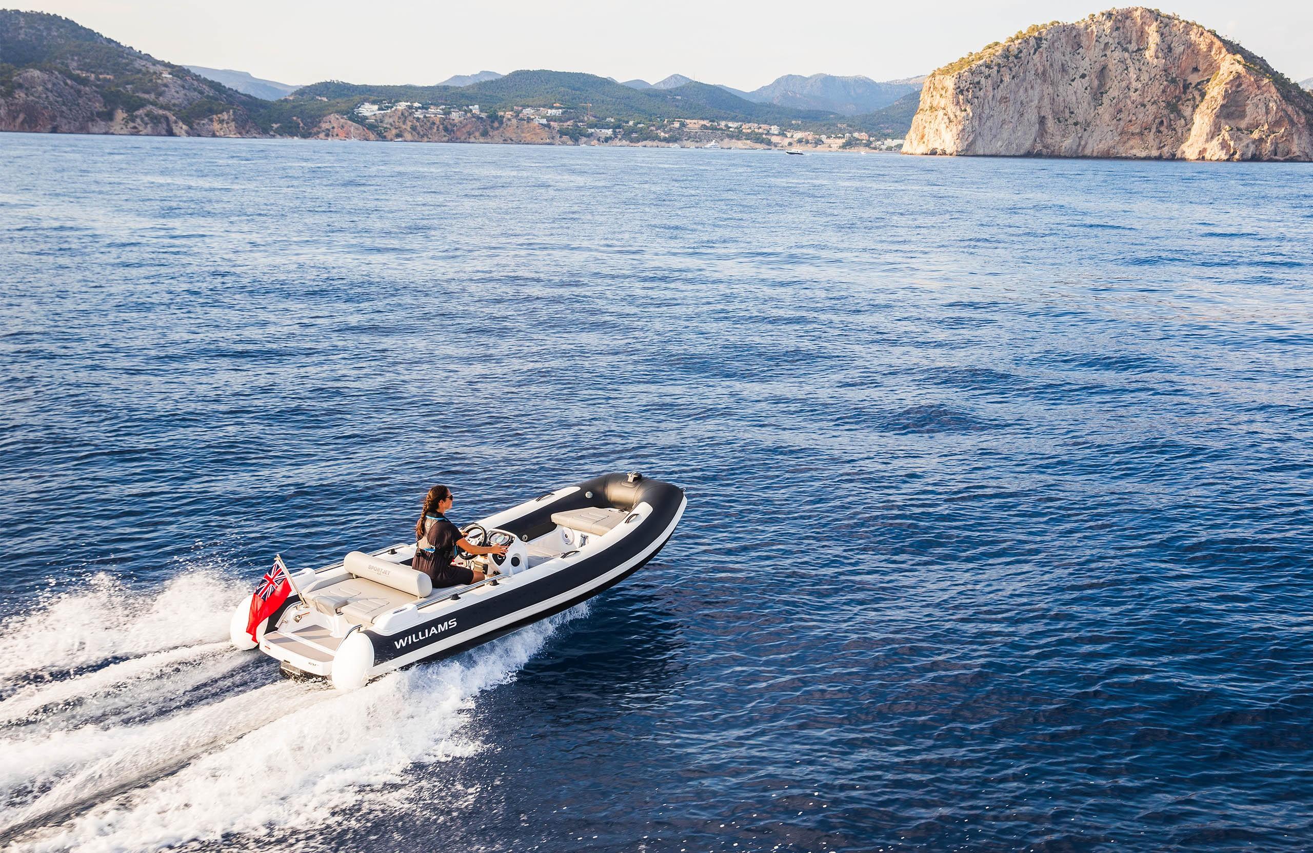 2025 Williams Jet Tenders Sportjet 435 cruising on open water with scenic coastal backdrop.